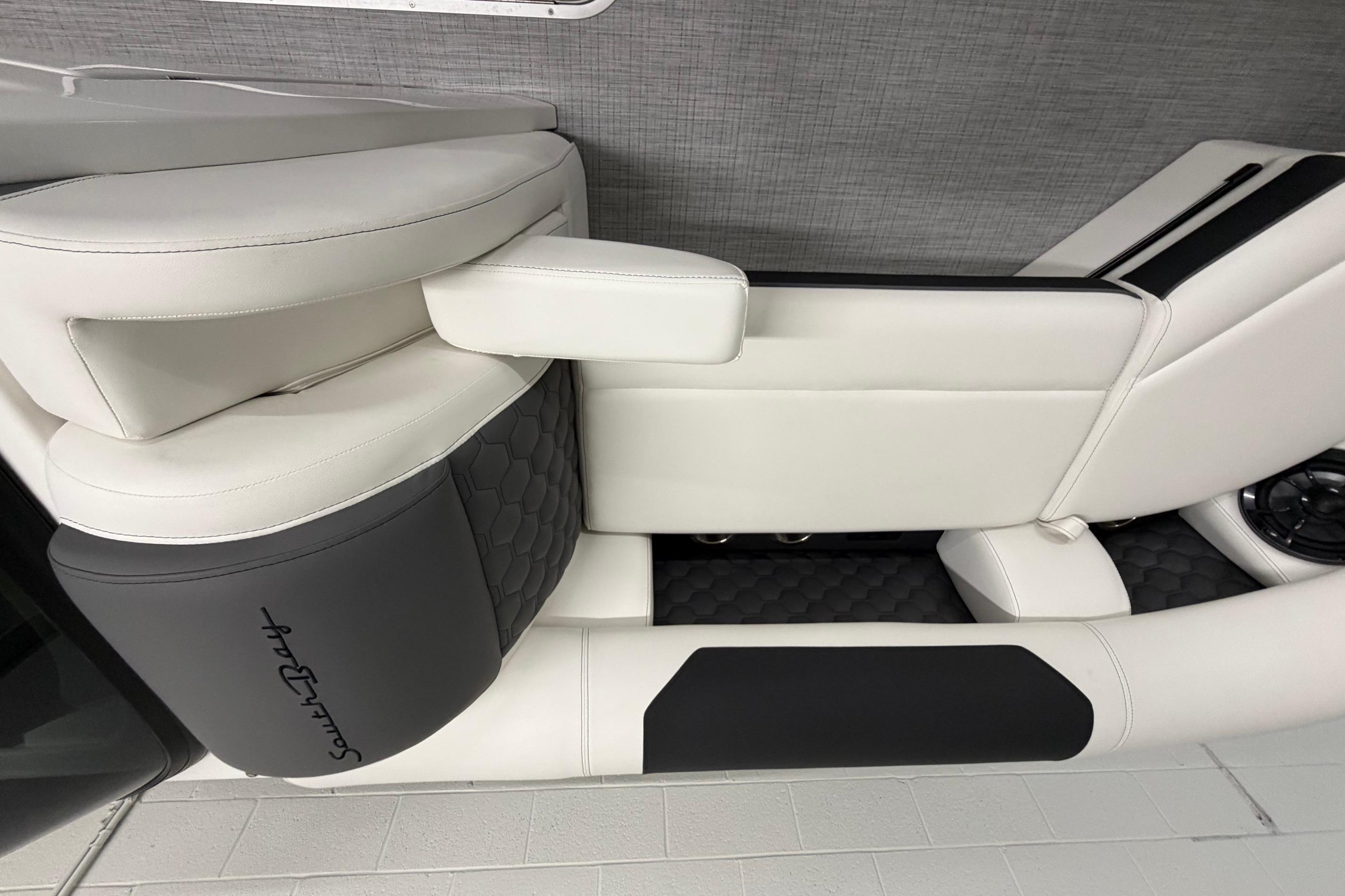 Luxurious seating in 2026 South Bay 525SB2 boat, featuring sleek white and black upholstery.