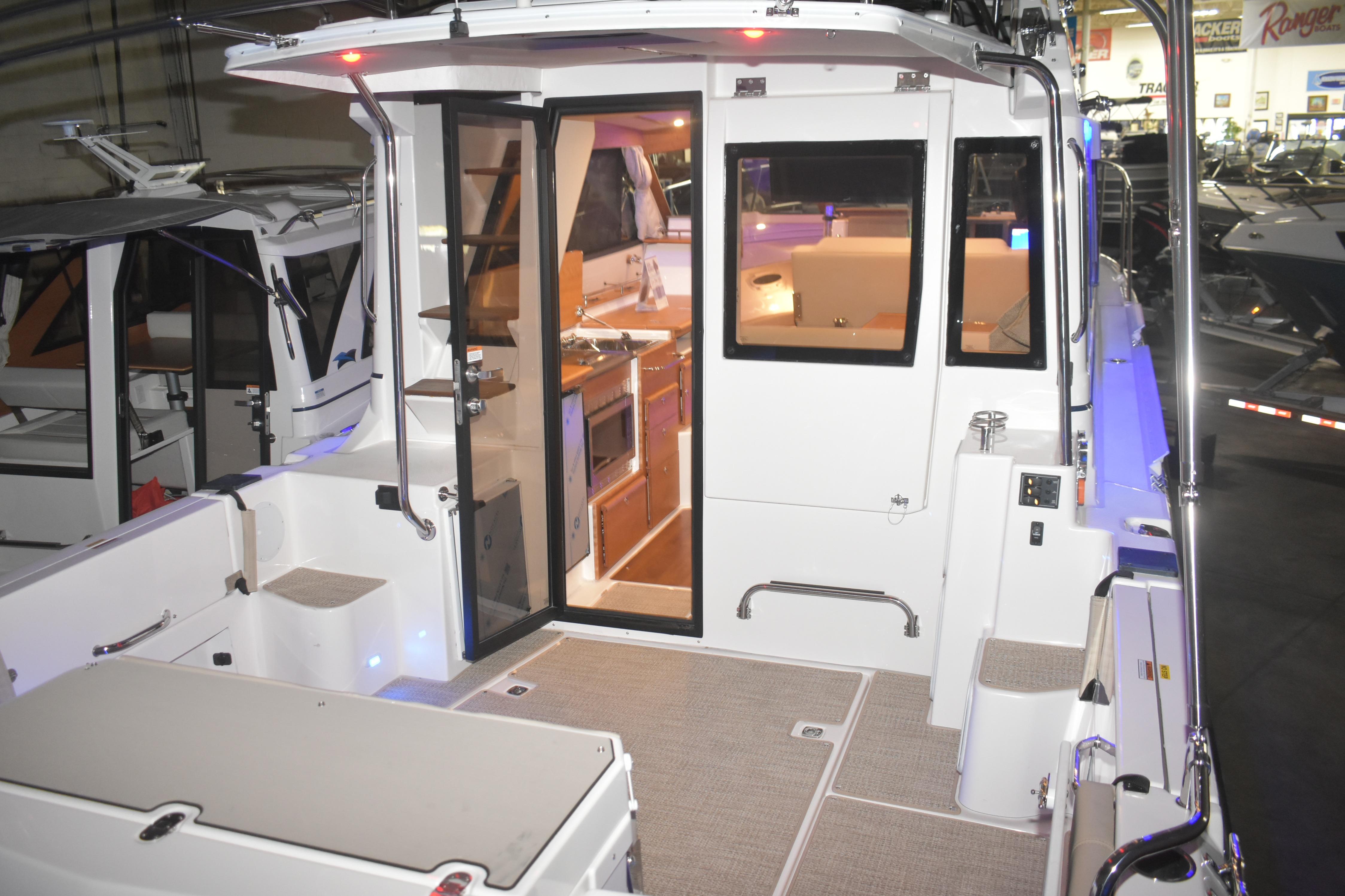 2026 Cutwater C-32 CB boat interior with modern kitchen and seating area.