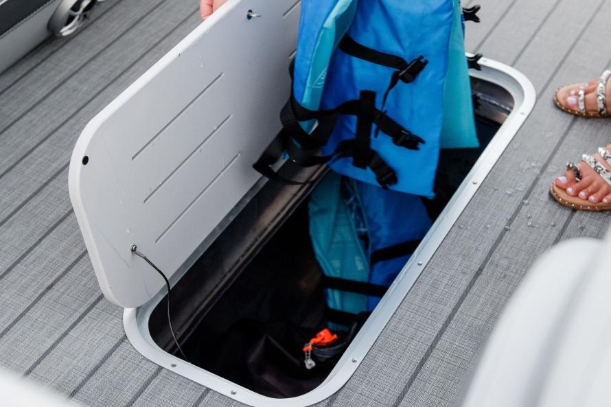Storage compartment on 2025 Bentley Pontoons Elite 253 QSB with life jackets.