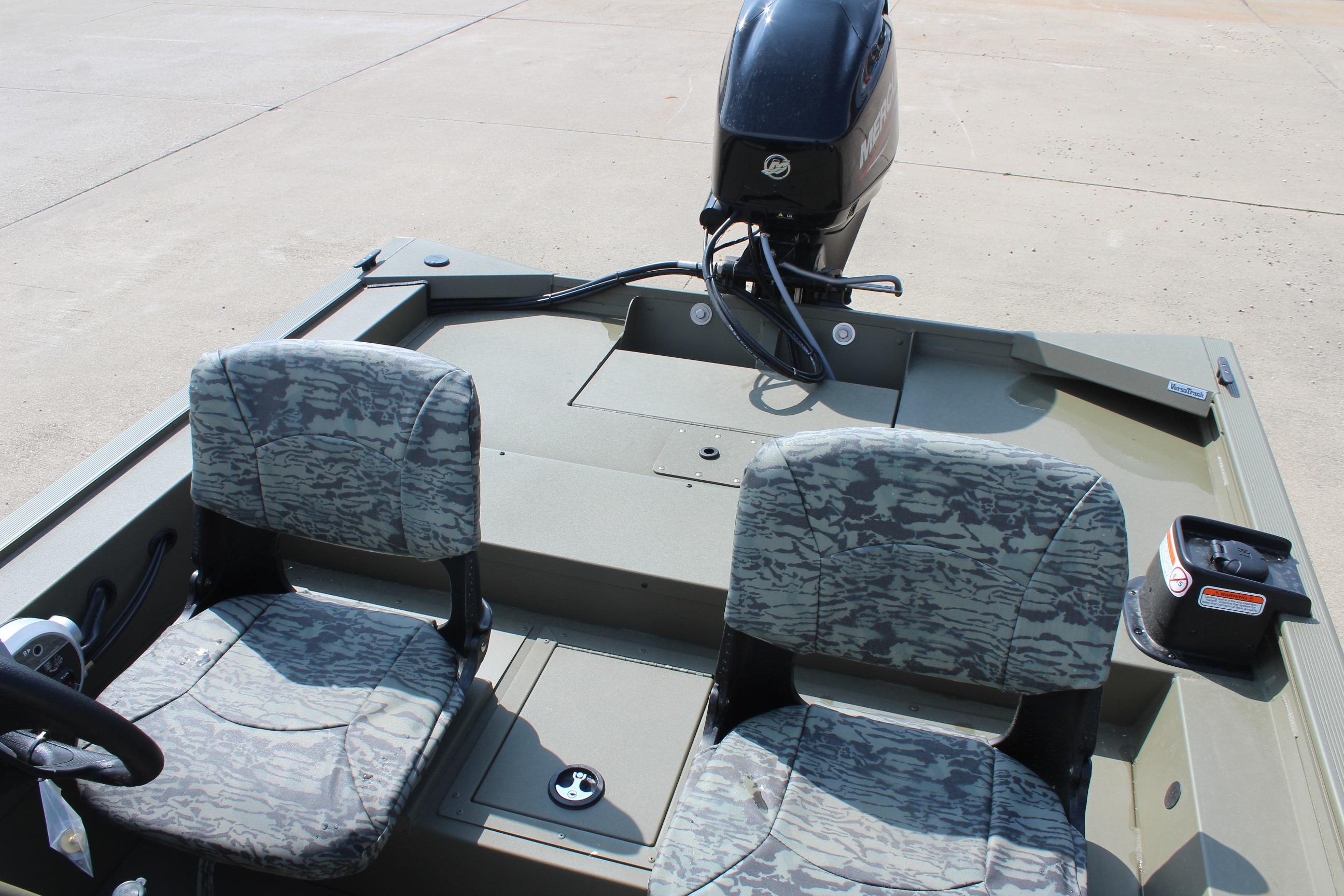 2026 Tracker Grizzly 1754 SC boat interior with camo seats and motor.