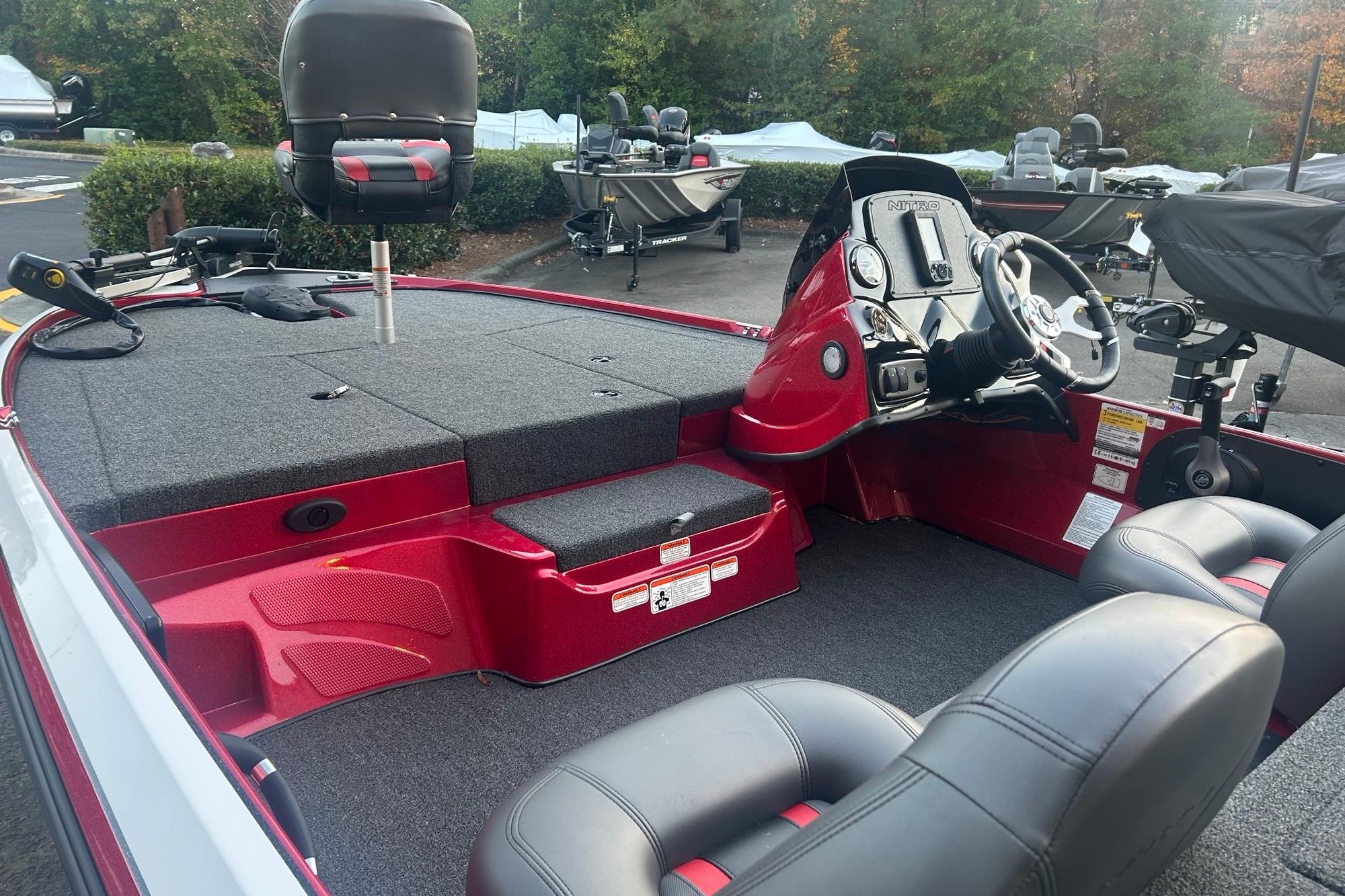 2026 Nitro Z17 boat interior with steering console and seating, parked outdoors.