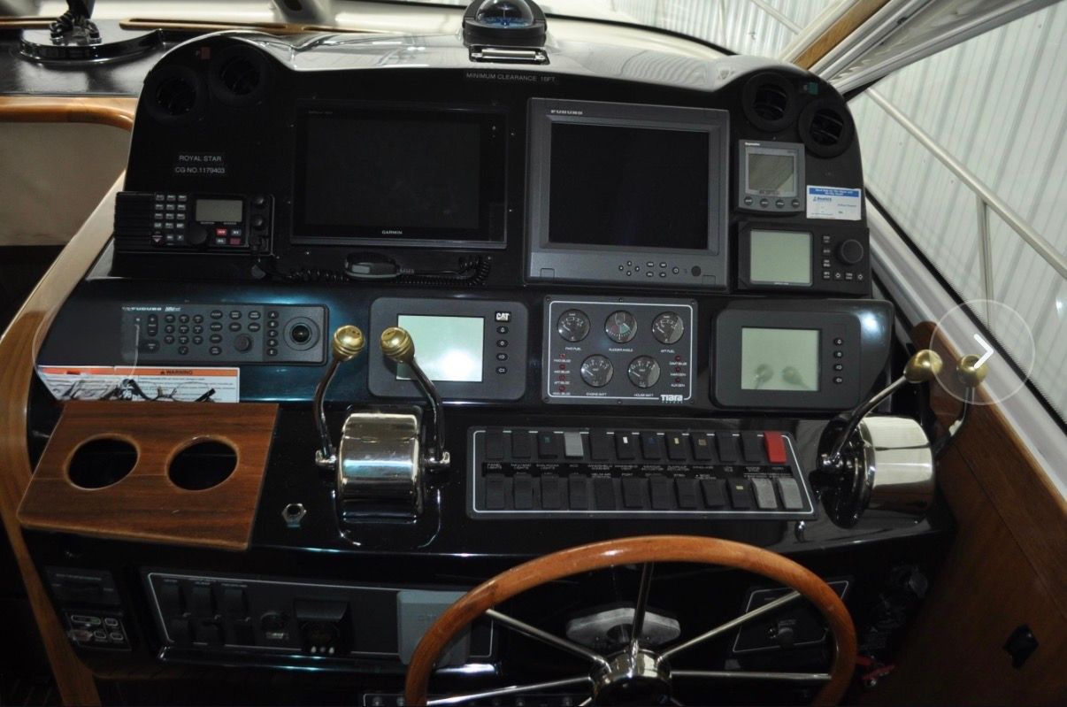 The image shows the dashboard of a 2005 Tiara Yachts 5200 Sovran with various instruments and screens.