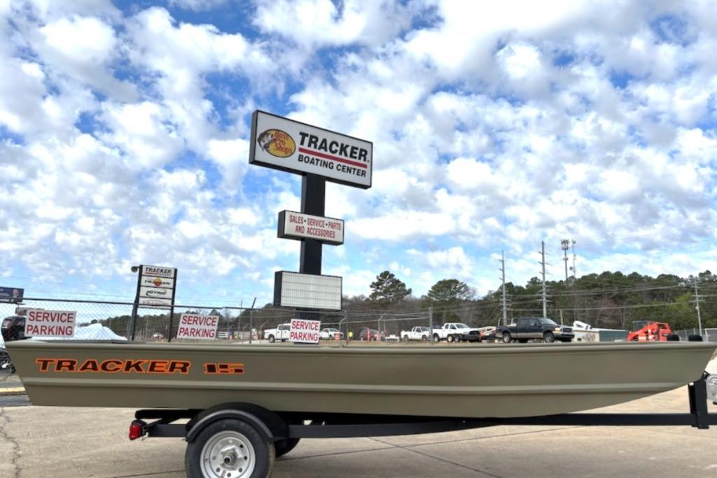 2025 Tracker Grizzly 1236 Utility boat at Tracker Boating Center under cloudy sky.