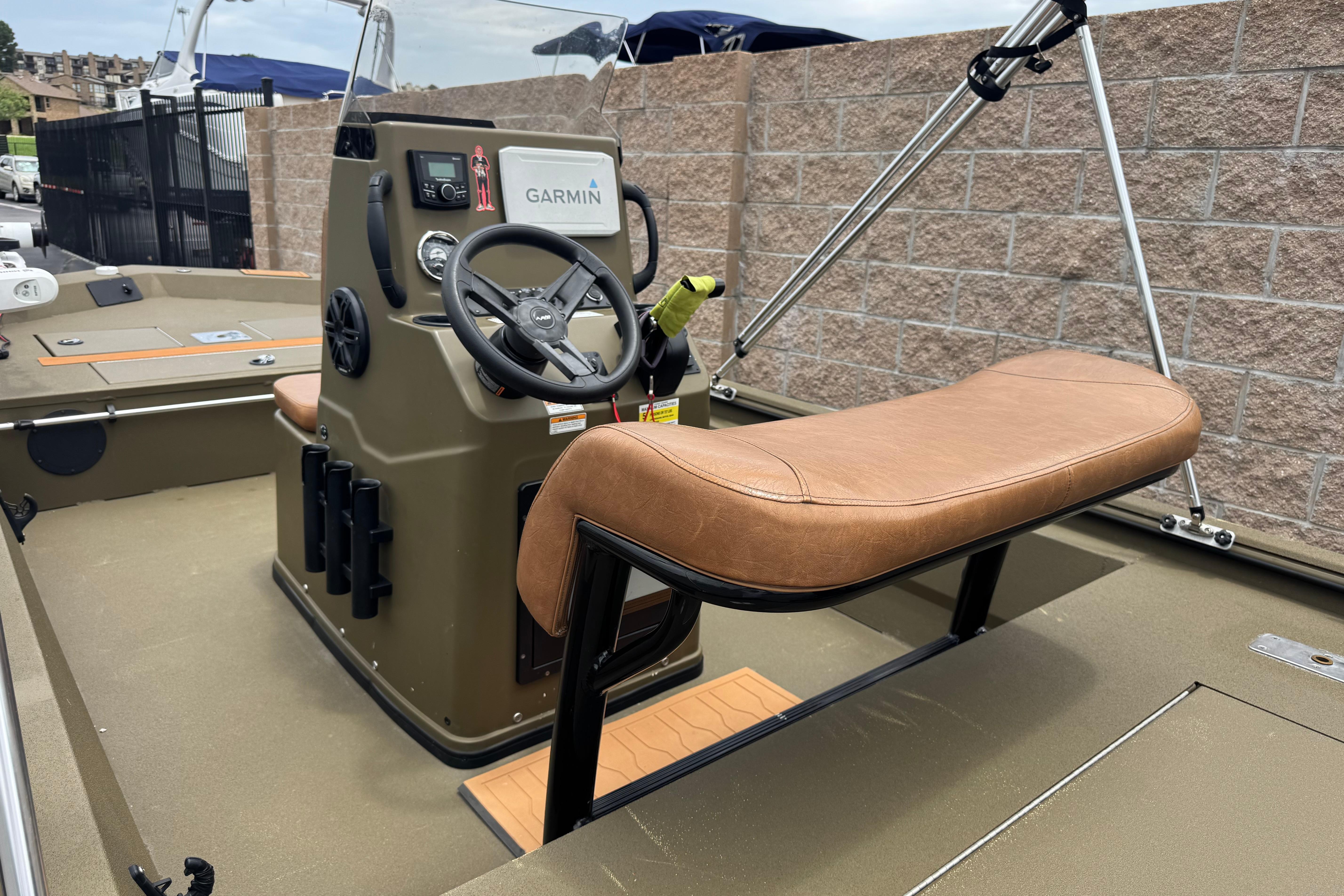 2023 Avid 18 Rogue CC boat interior with Garmin navigation system and tan seating.
