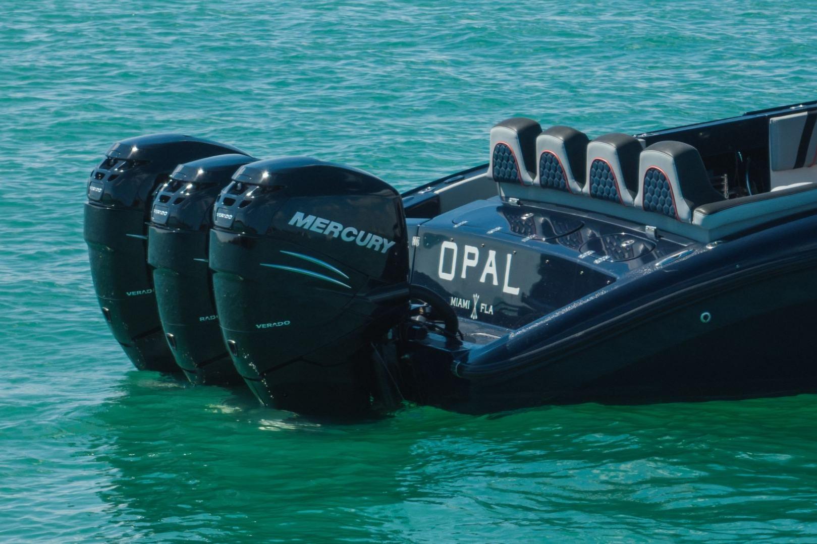 2014 Midnight Express 37 Open boat with triple Mercury Verado engines on turquoise water.