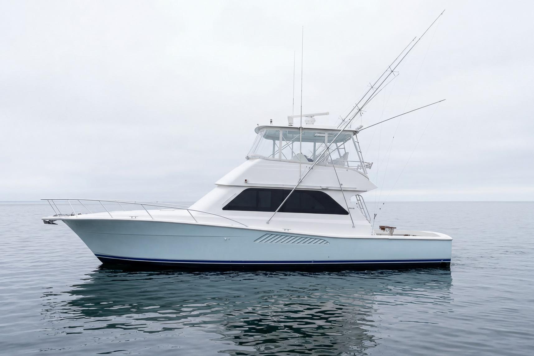 2000 Viking 50' Convertible yacht on calm water, showcasing sleek design and fishing equipment.