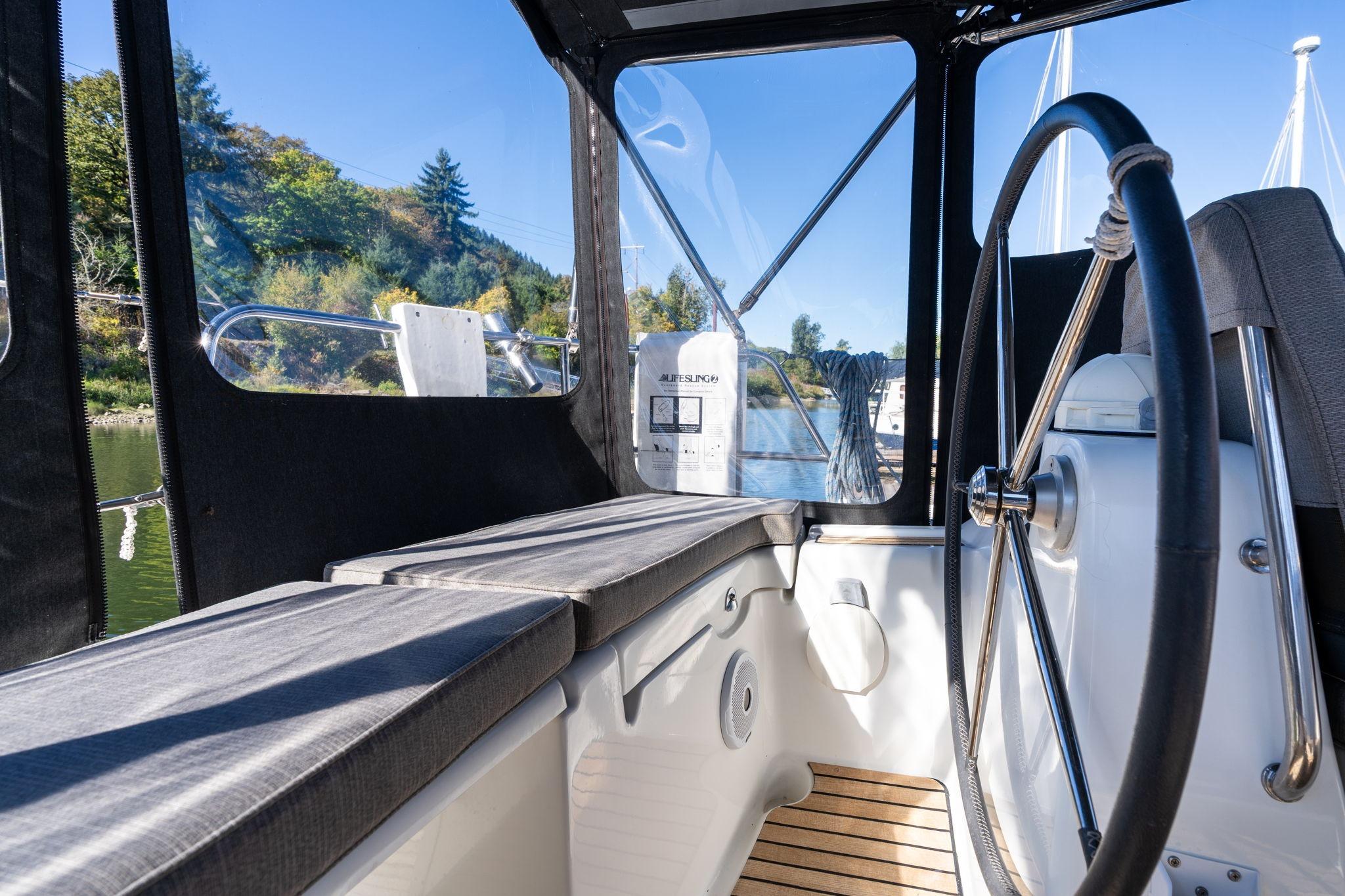 Interior view of 2013 Beneteau Oceanis 50 sailboat cockpit with steering wheel.