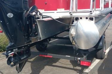 2026 Sun Tracker Bass Buggy 18 DLX pontoon boat rear view with motor and trailer.