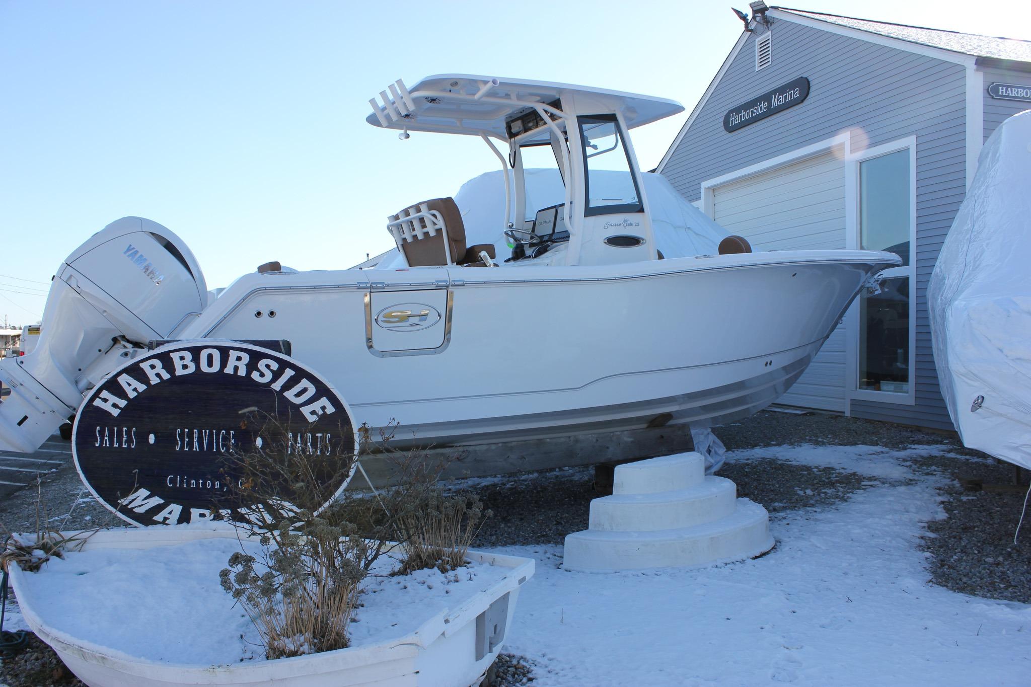 2026 Sea Hunt Gamefish 25 boat displayed at Harborside Marina in winter setting.