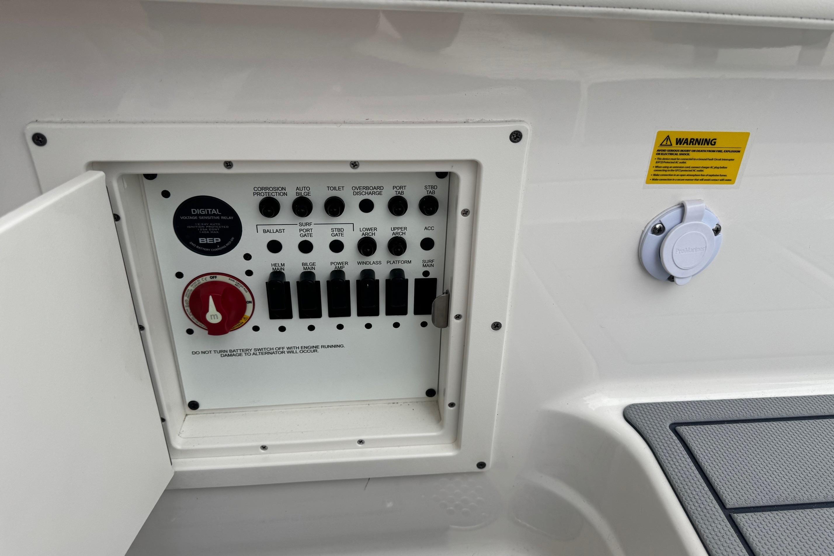 Control panel of 2026 Chaparral 8 SSX boat with switches and warning label.