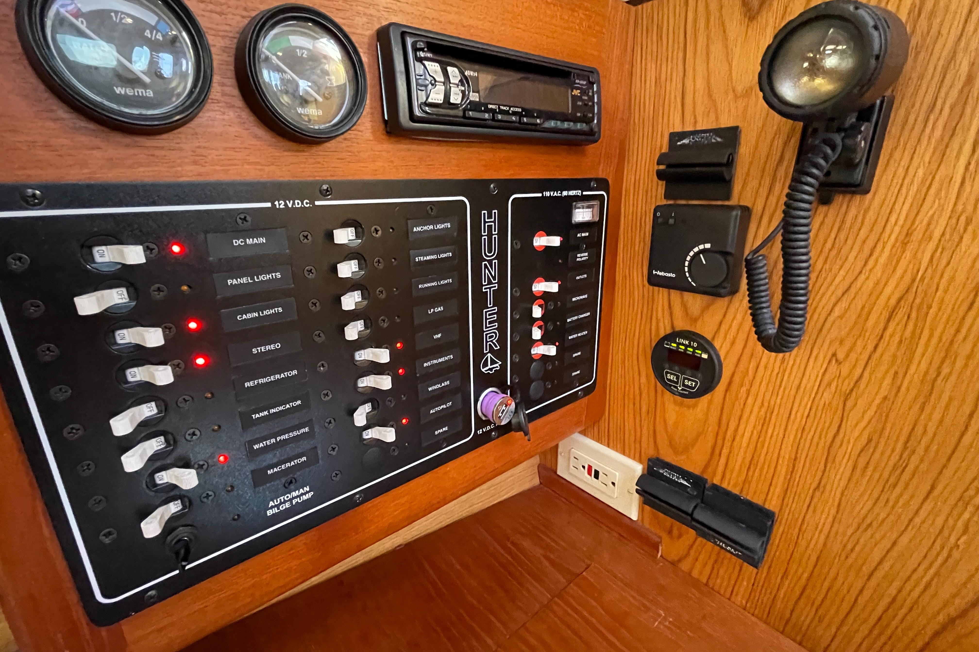 Control panel of a 2000 Hunter 340 sailboat with gauges and switches.