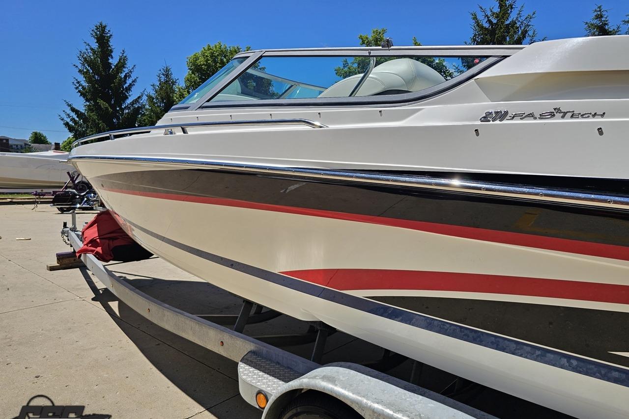 2005 Formula 271 FASTech boat on trailer, sleek design with red and black accents.