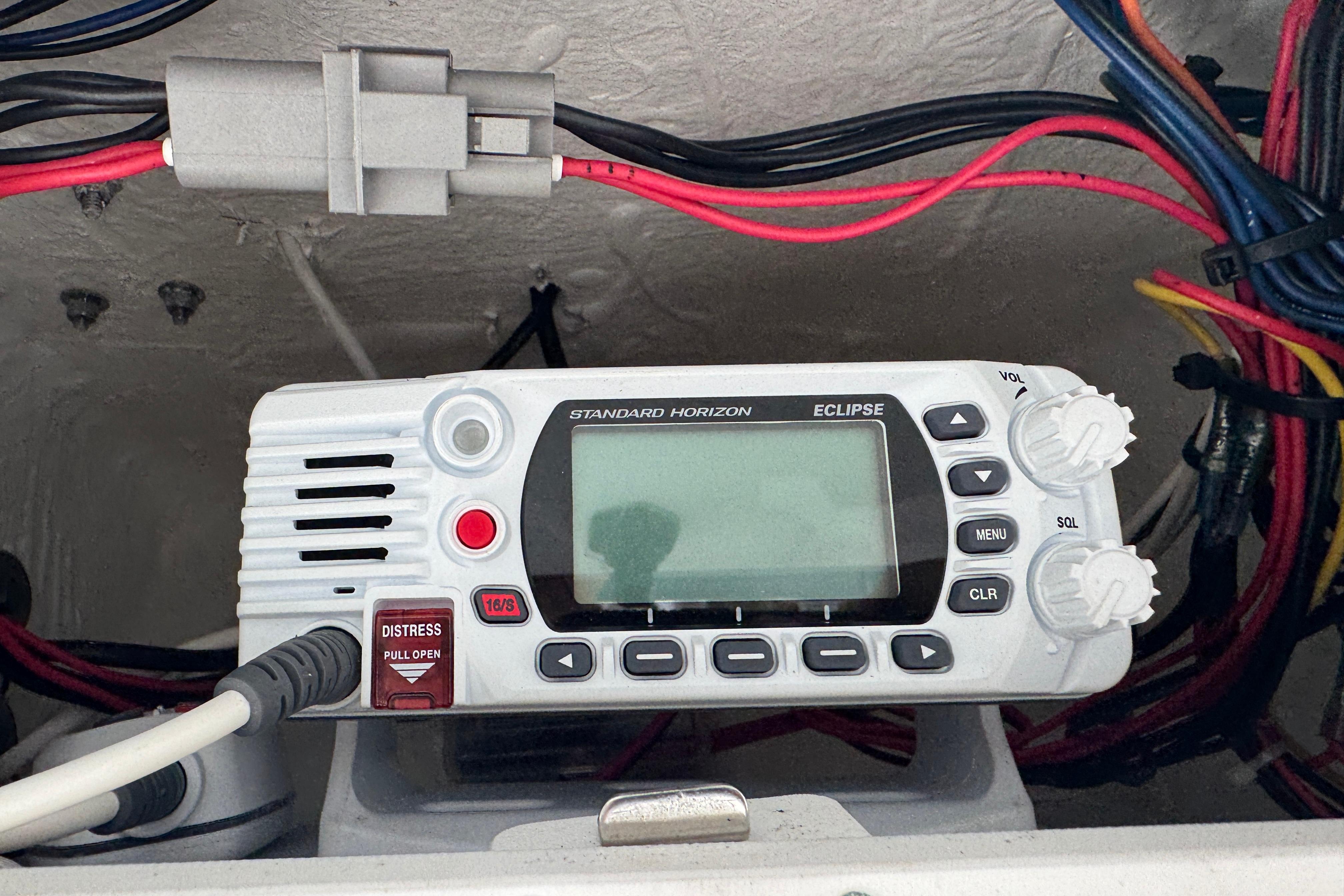 Standard Horizon Eclipse radio on 2022 Tidewater 232 SS boat, surrounded by colorful wiring.
