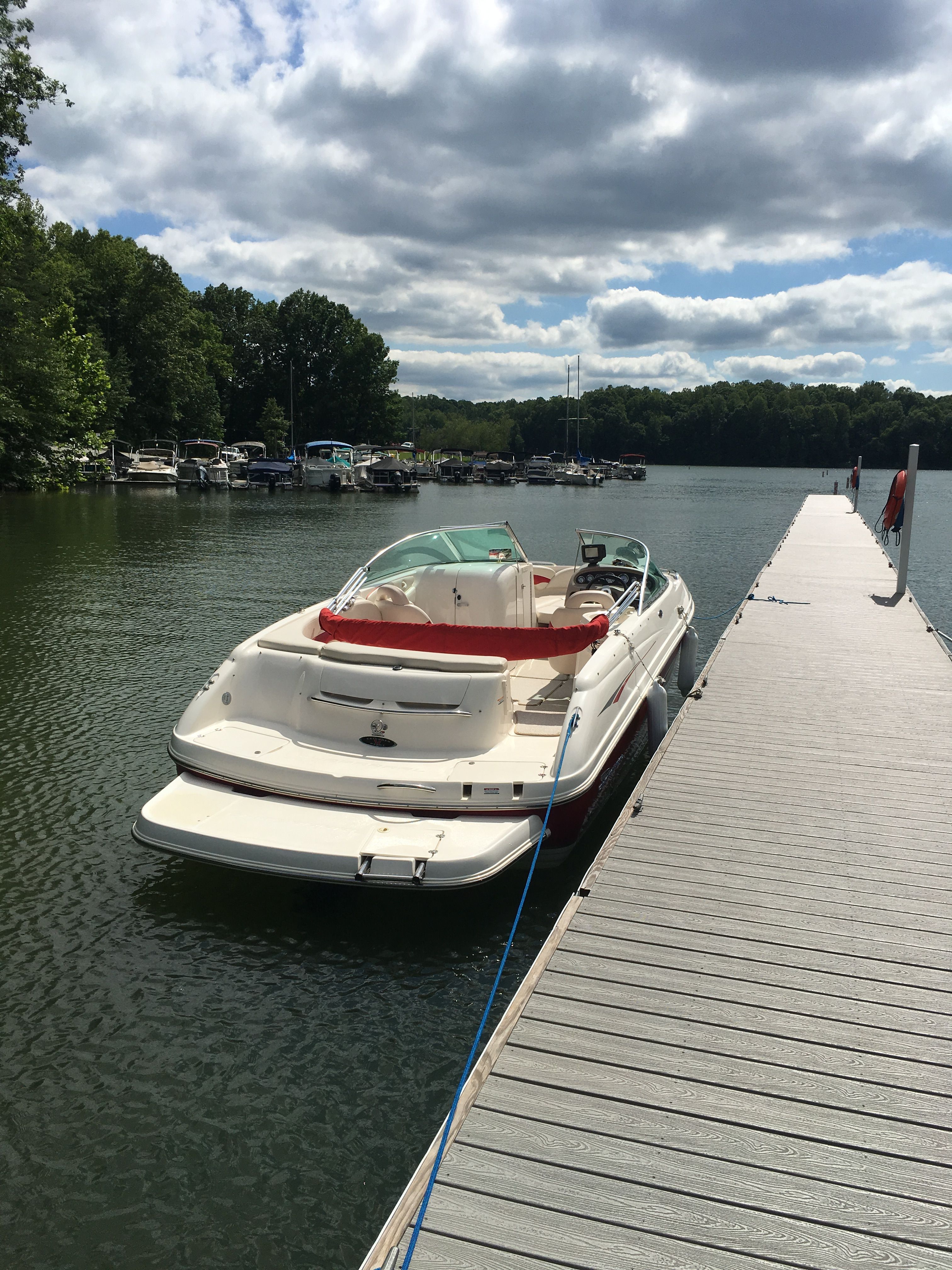 2000 Chaparral 230 SSi boat docked by a pier.