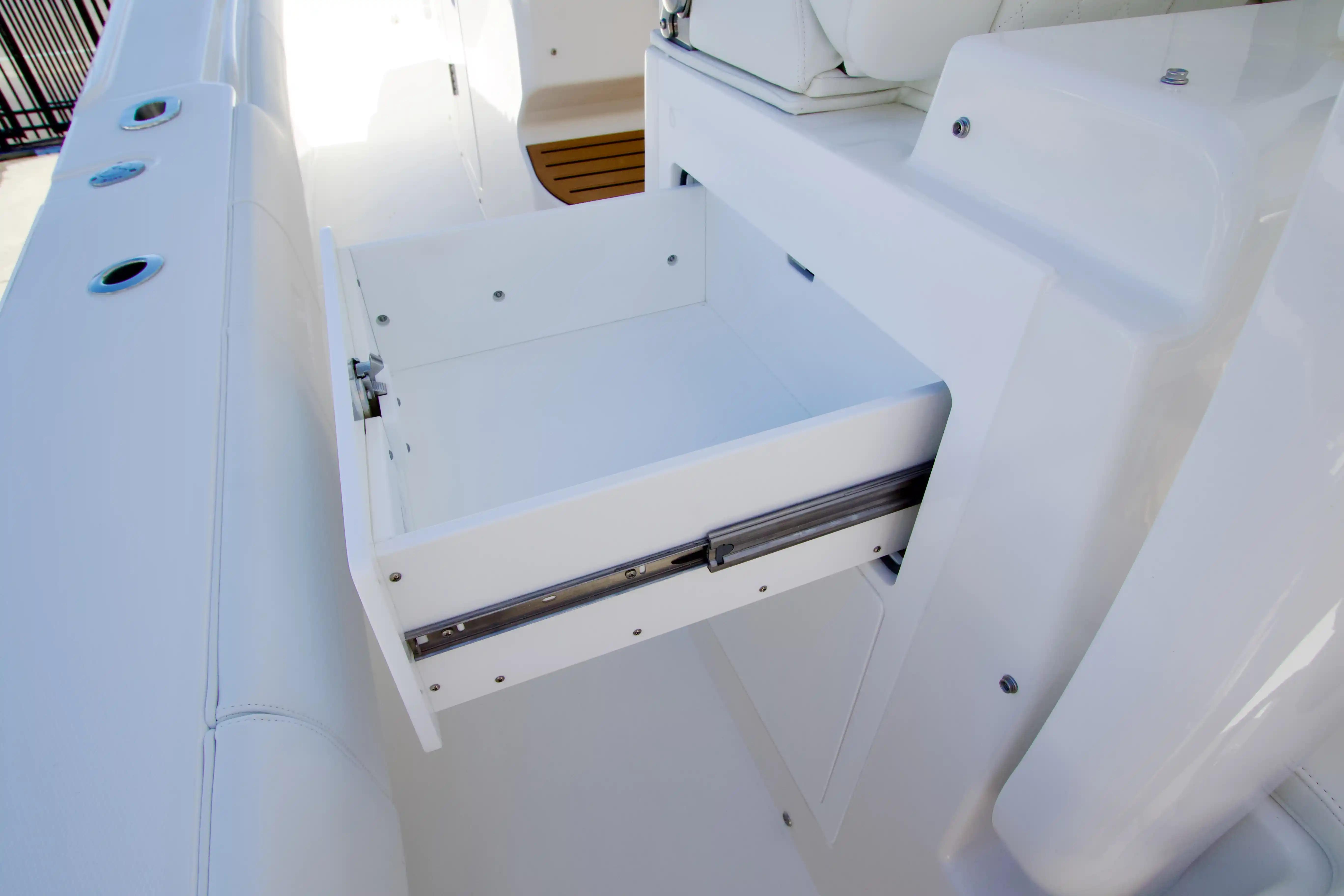 Open storage drawer on 2027 Regulator 35 boat, showcasing sleek white design.
