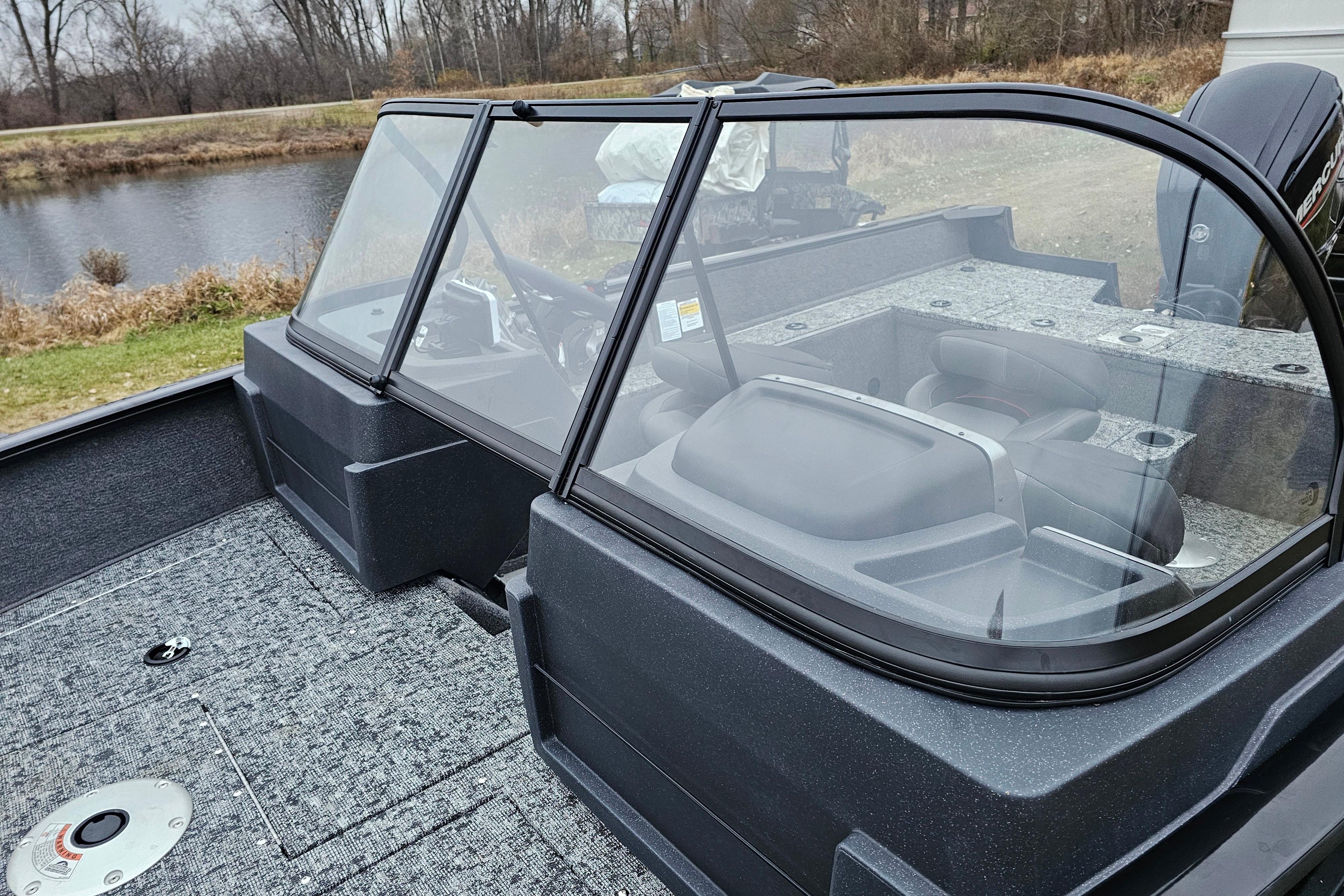 2026 Tracker Pro Guide V-175 WT boat with windshield, near a serene lake.