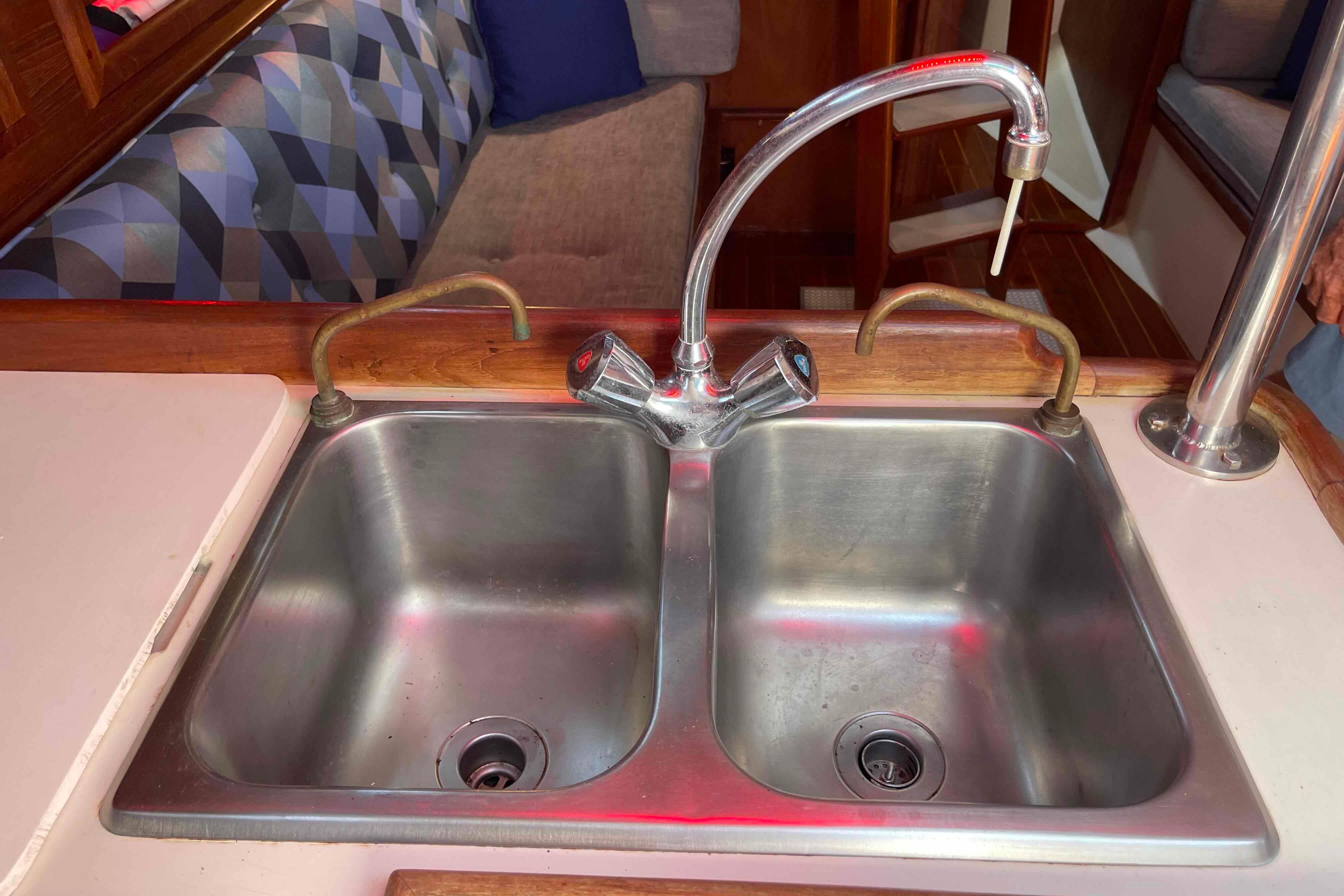 Stainless steel double sink in 1987 Pacific Seacraft 34 yacht galley.