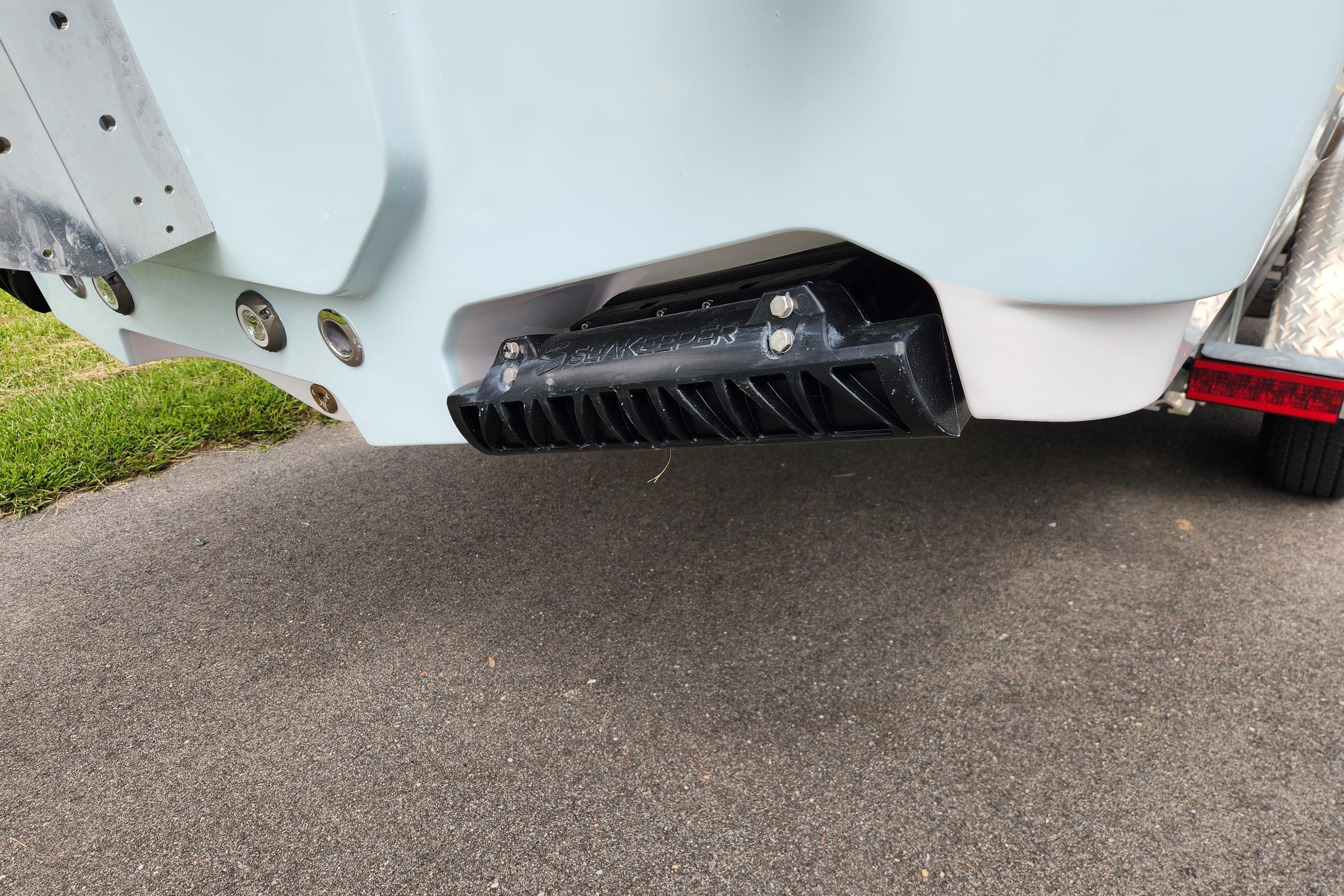 2026 Sportsman Masters 247 Bay Boat hull detail with trailer on pavement.