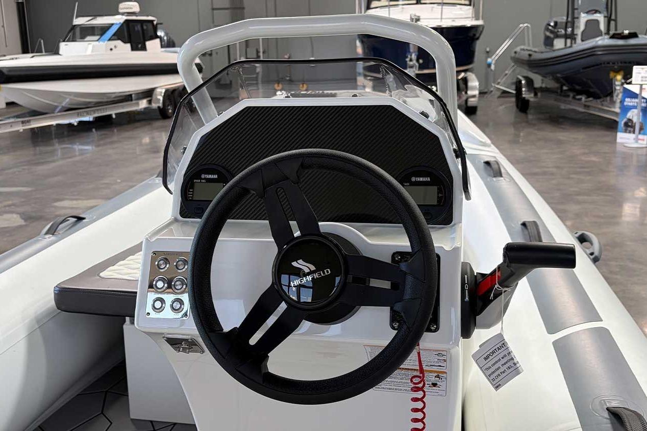 2026 Highfield Sport 460 boat interior with steering wheel and control panel.