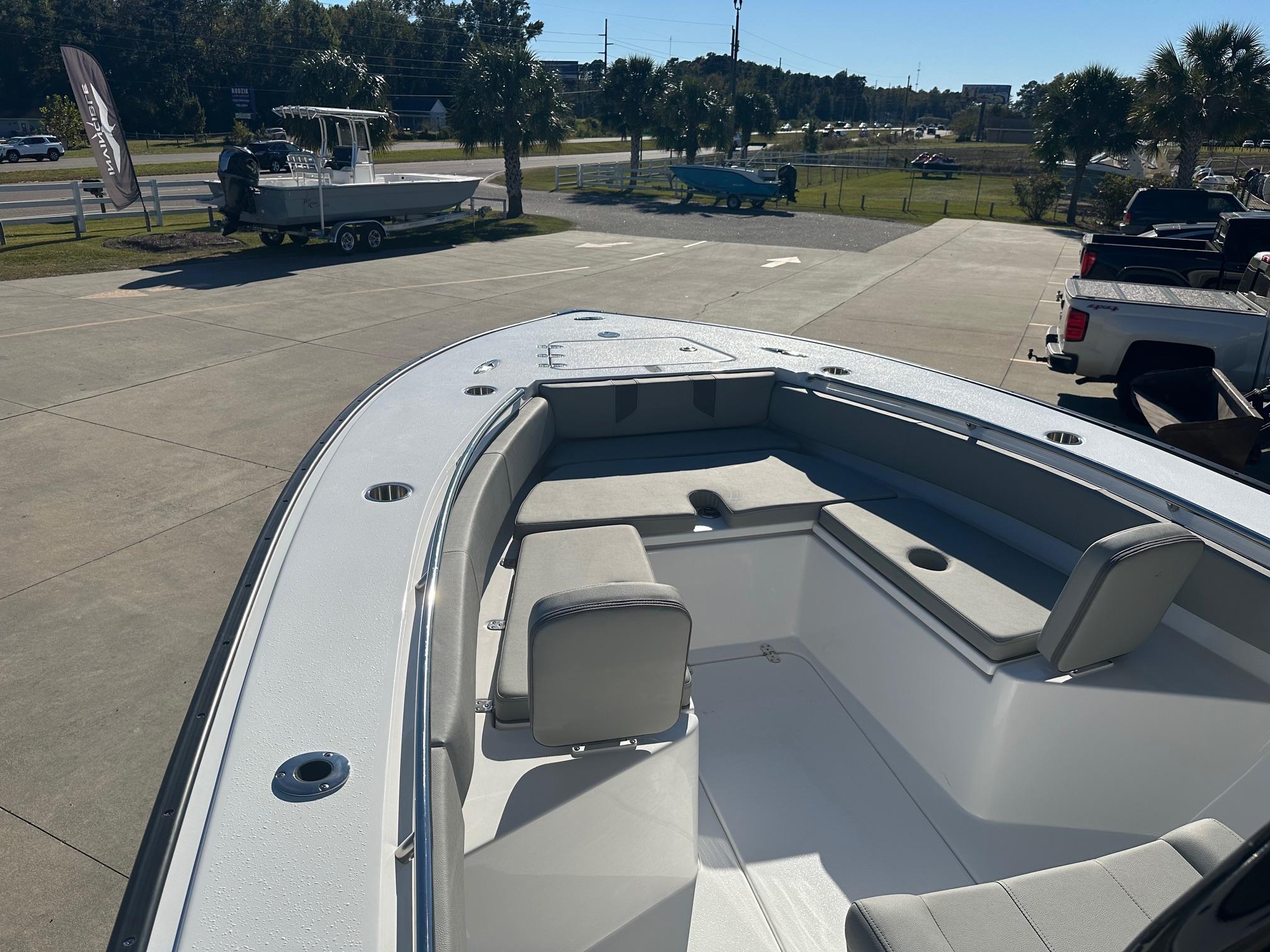2025 Cape Horn 28XS boat with spacious seating, parked outdoors on a sunny day.