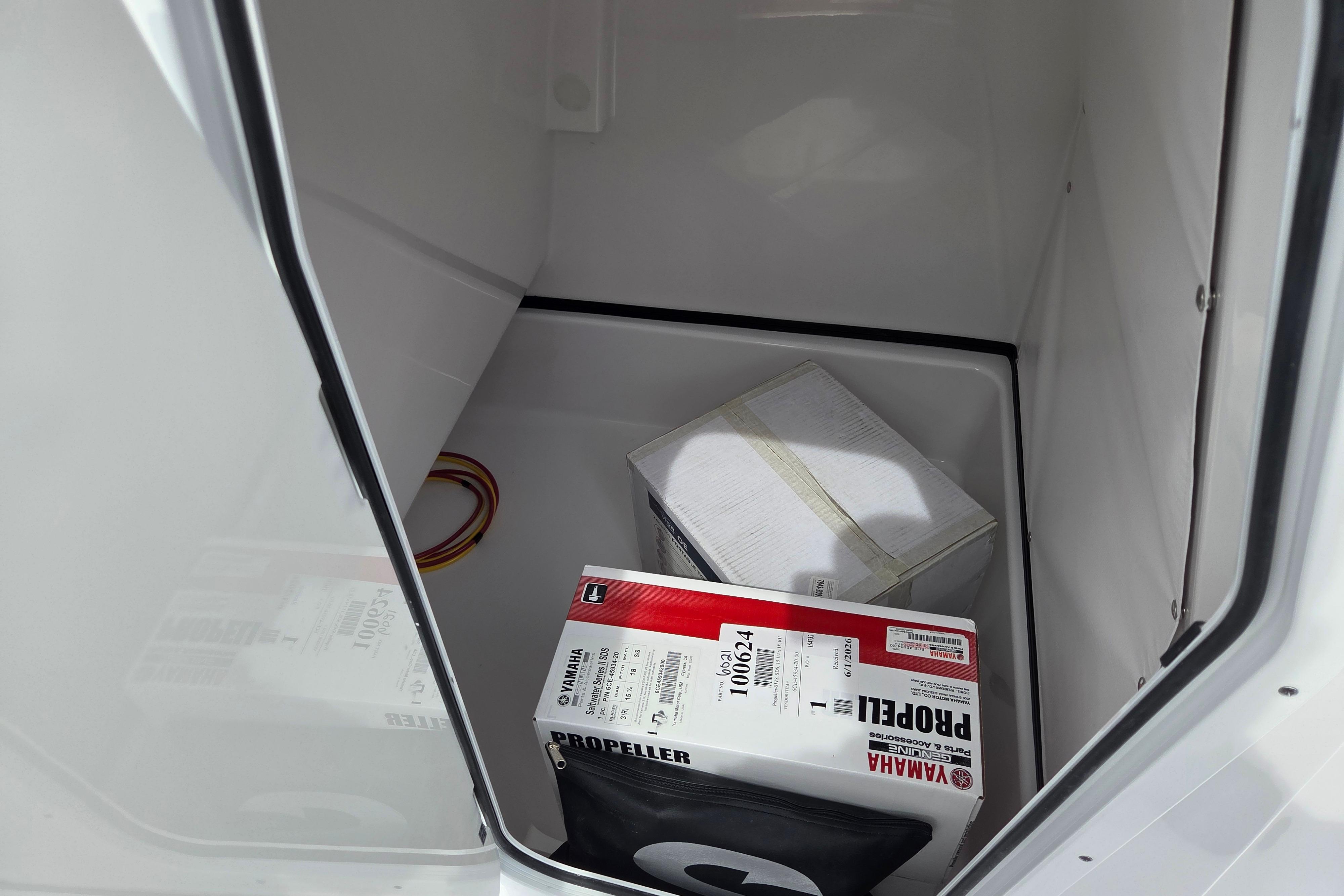 Storage compartment of 2026 Sportsman Masters 247OE Bay Boat with Yamaha propeller box.