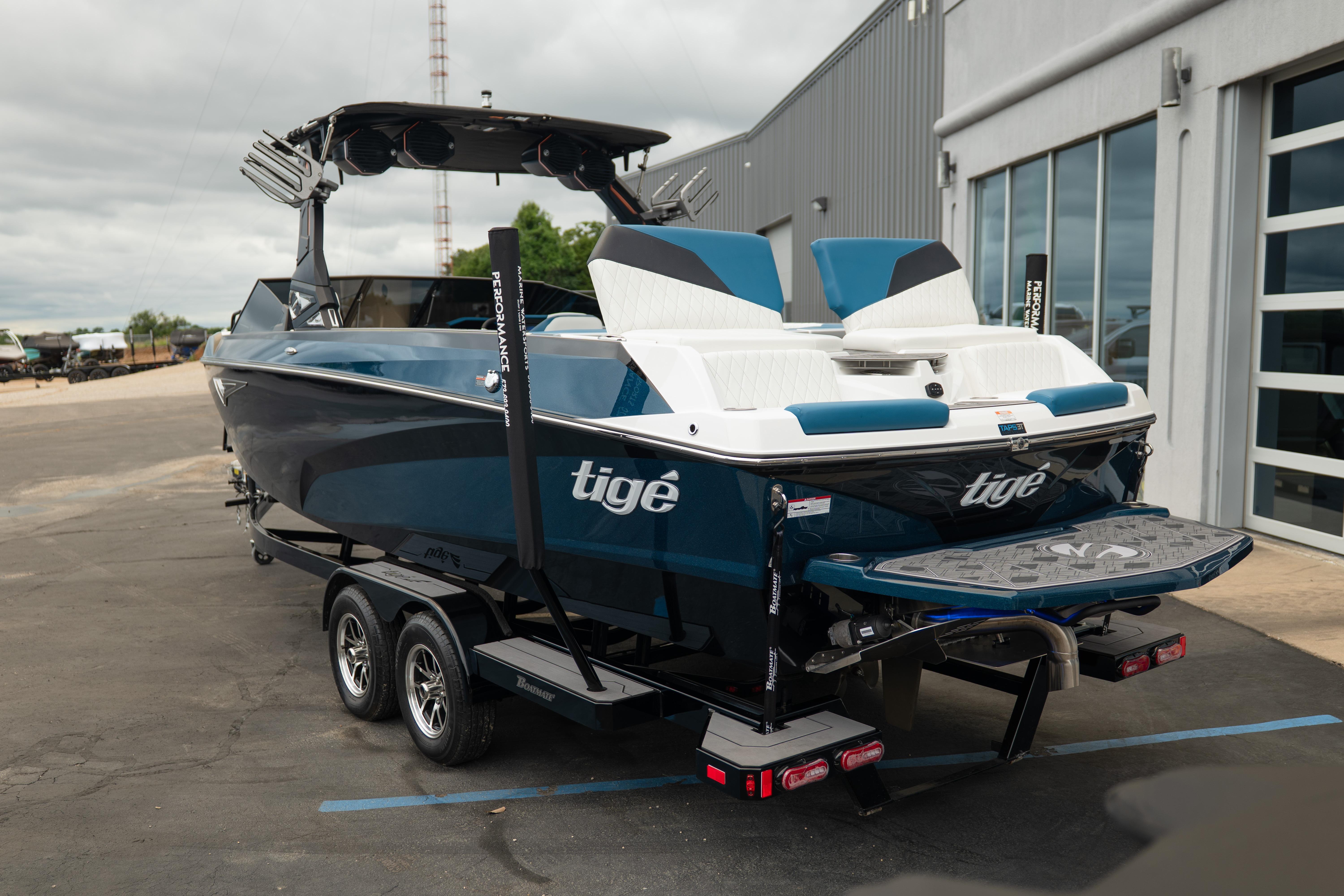 2024 Tigé Z5 boat on trailer, parked outside a modern building.