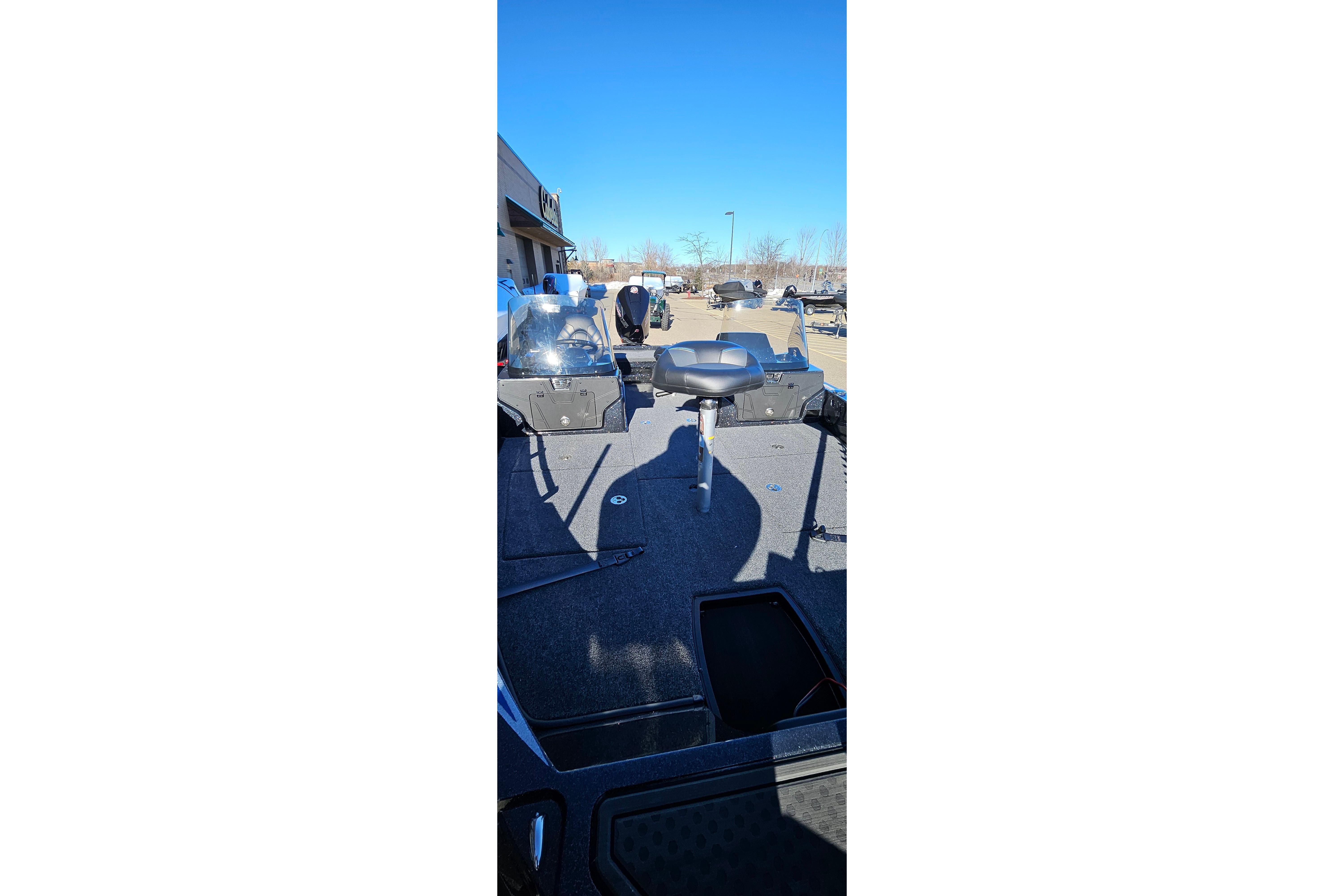 2025 Nitro ZV20 boat interior with seating and control panel under clear blue sky.