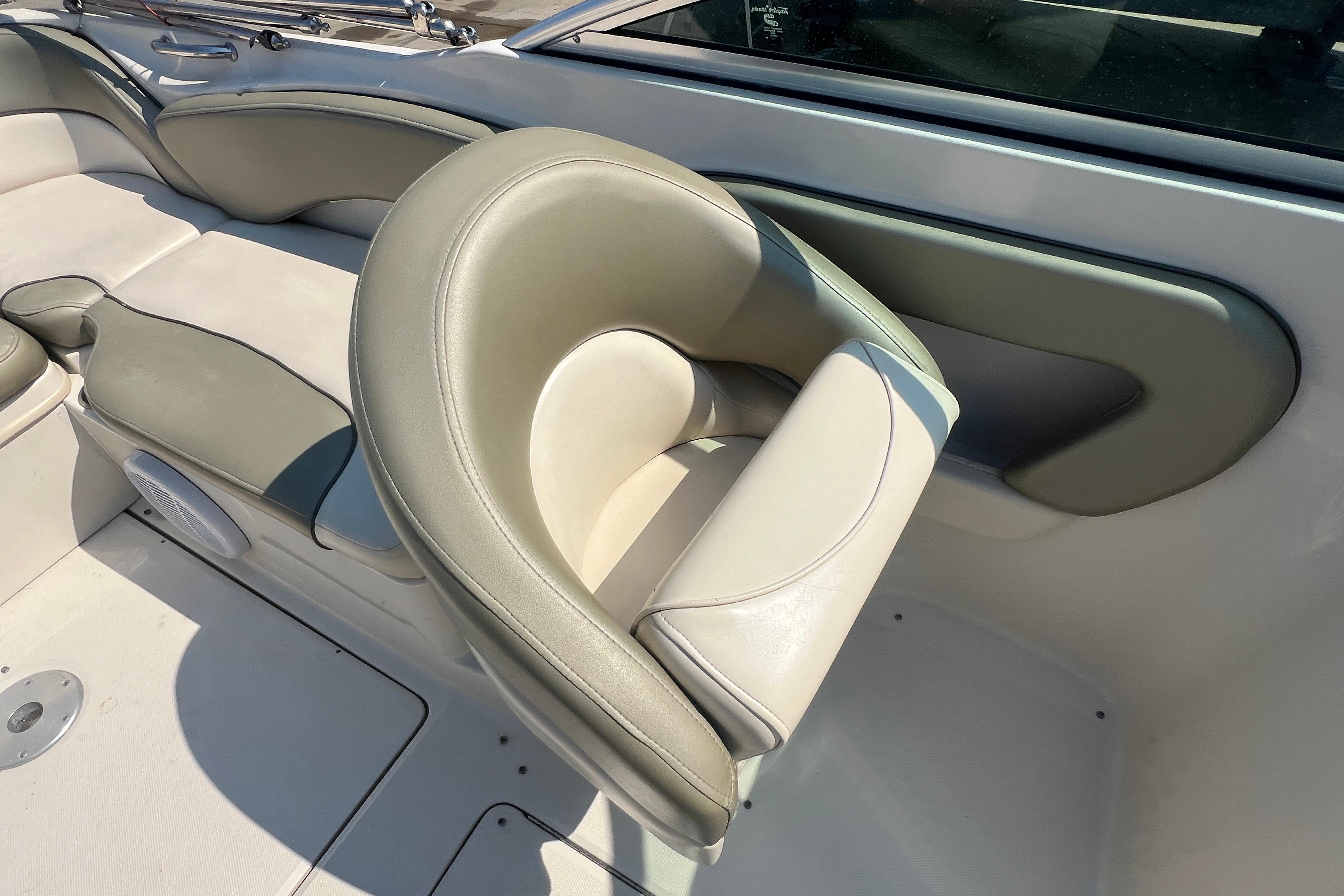 2005 Sea Ray 240 Sundeck interior with beige seating and speaker detail.