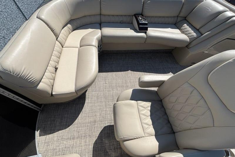 Luxurious seating on a 2014 Bennington 2575 RCW pontoon boat, featuring beige upholstery.