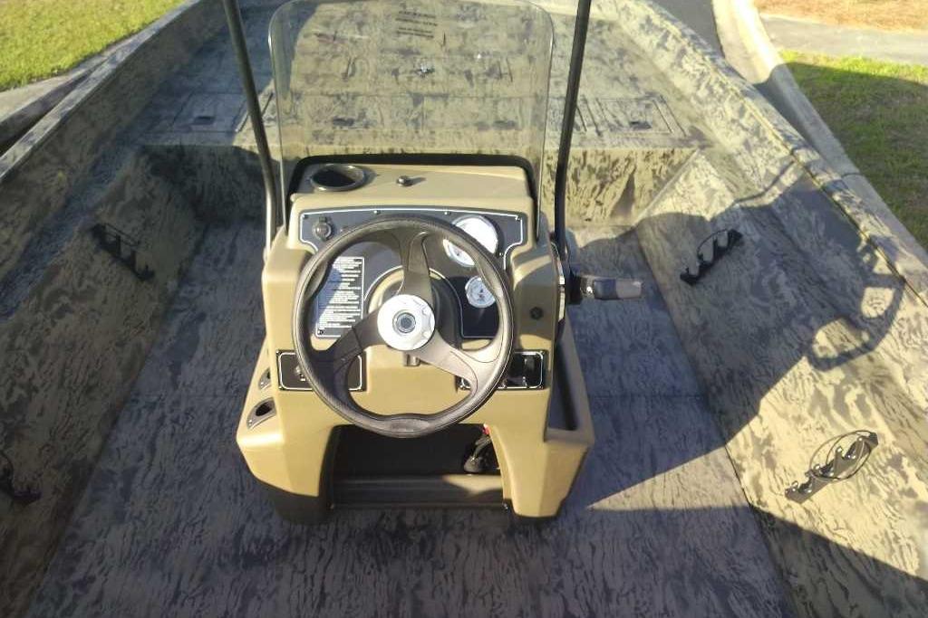 2026 Tracker Grizzly 2072 CC boat interior with steering console and camouflage design.