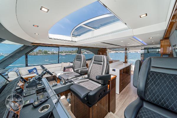 Interior of 2025 Riviera 645 SUV yacht with luxurious seating and panoramic windows.