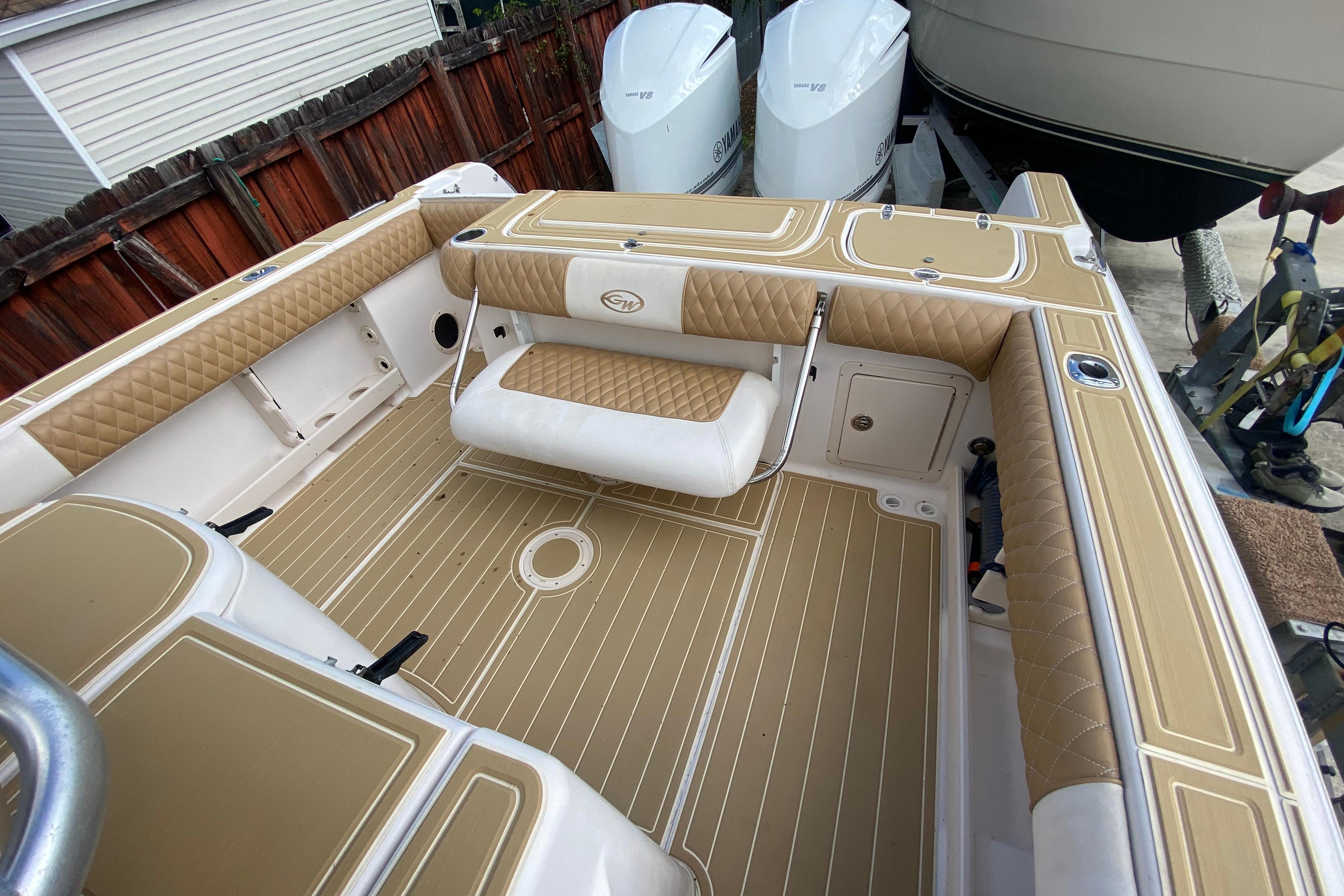 2004 Grady-White Canyon 283 boat interior with tan and white seating and deck.