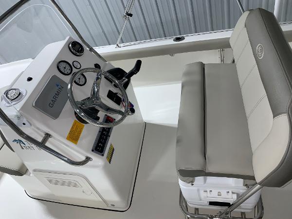 2026 Key West 188 Bay Reef boat interior with steering console and cushioned seating.