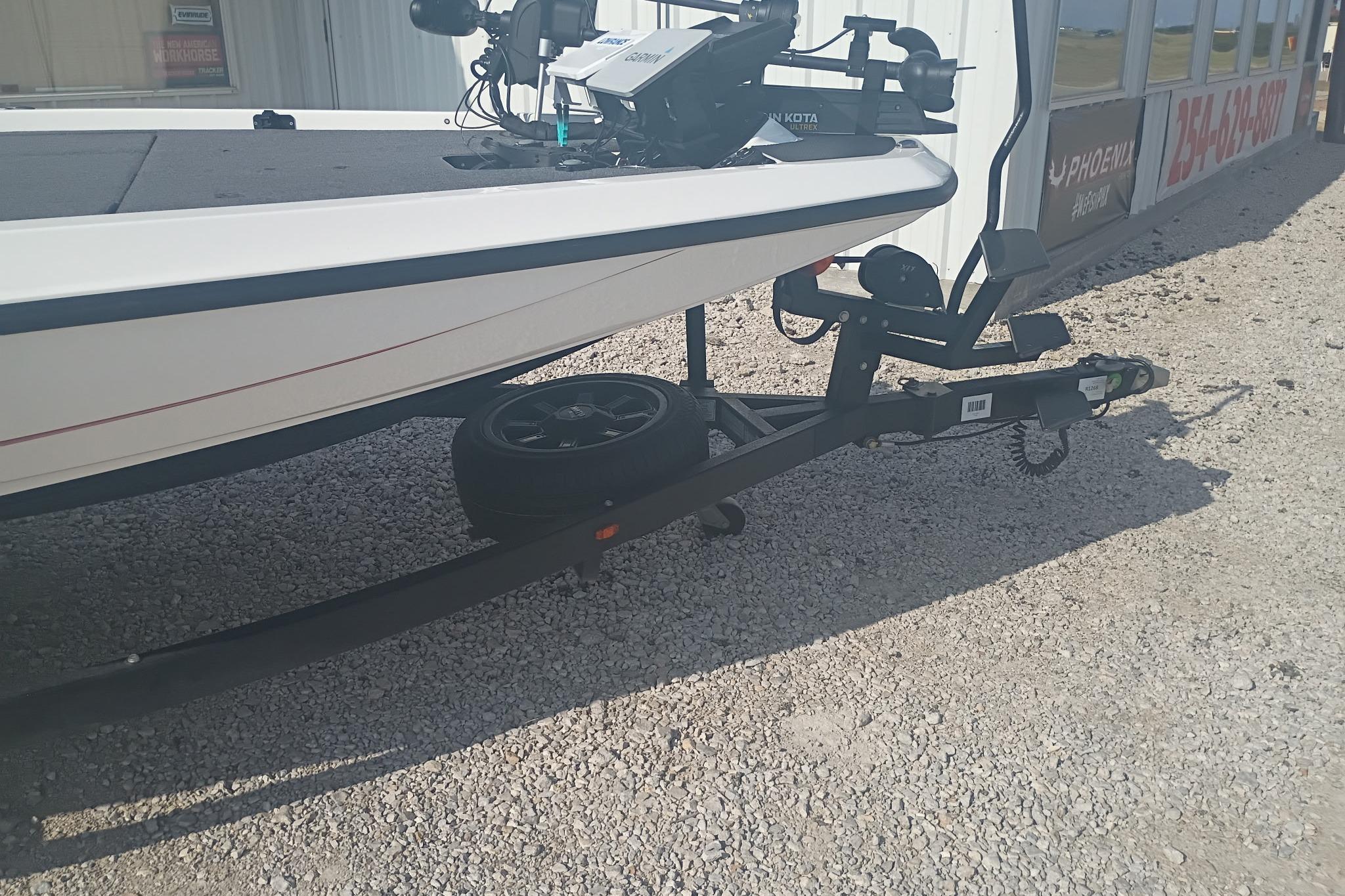 2024 iKon LX21 boat trailer with spare tire on gravel surface.