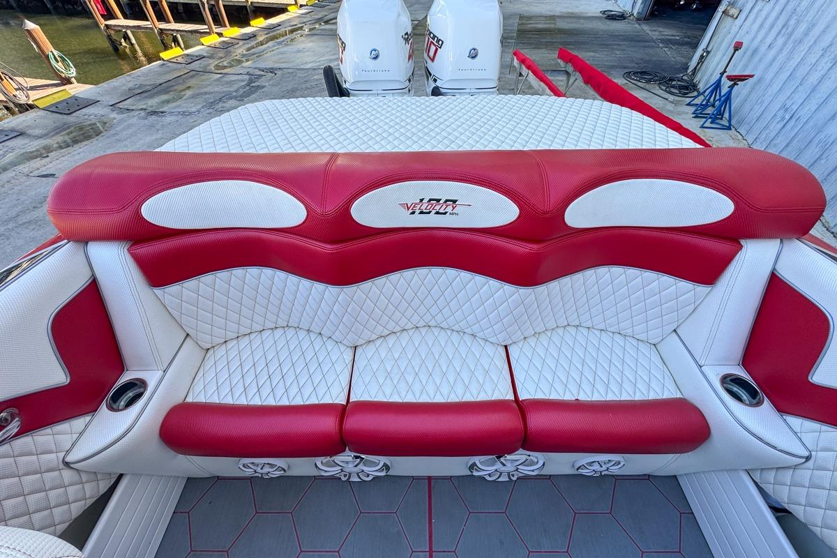 Red and white seating on 2022 Velocity 290sc boat, featuring quilted upholstery design.