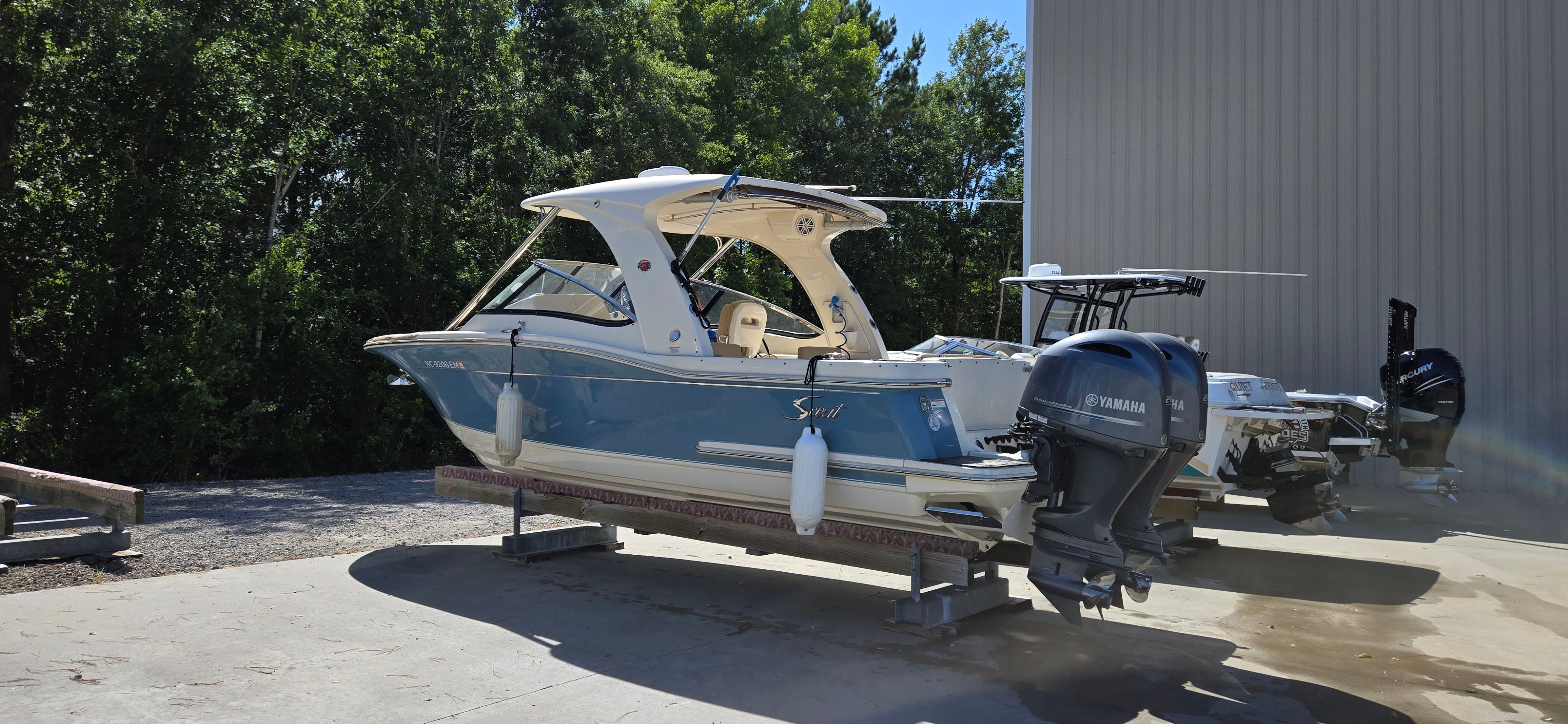 2019 Scout 275 Dorado boat with Yamaha engines on a dock.