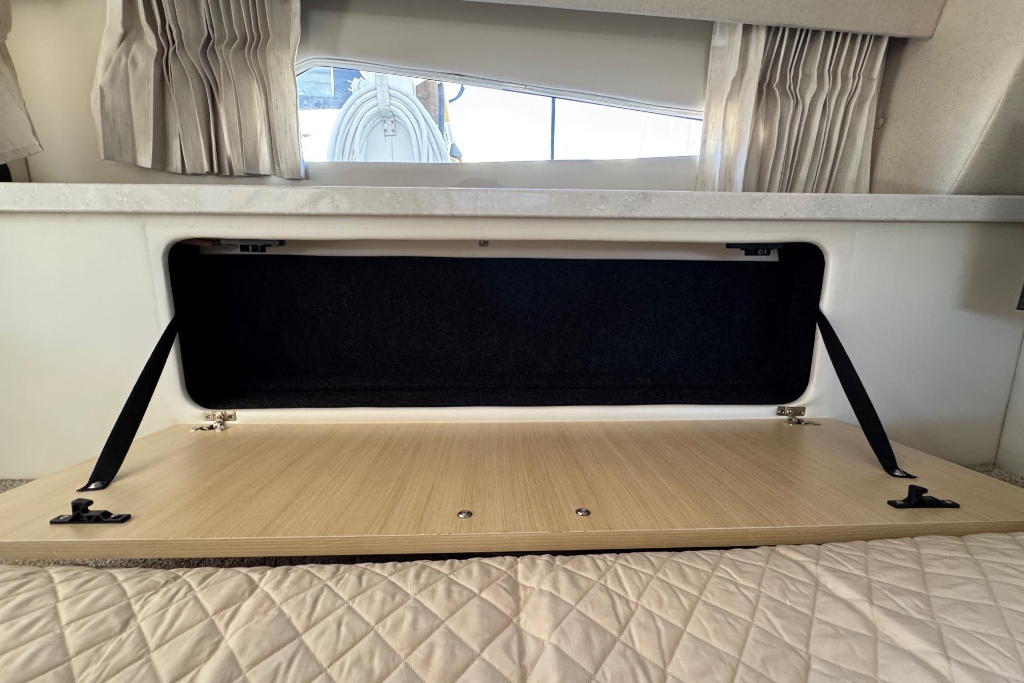 Open storage compartment in 2026 Regal 33 XO boat interior.