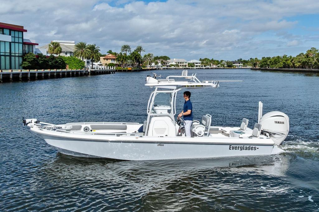 2023 Everglades 243 Center Console boat cruising on a scenic waterway.