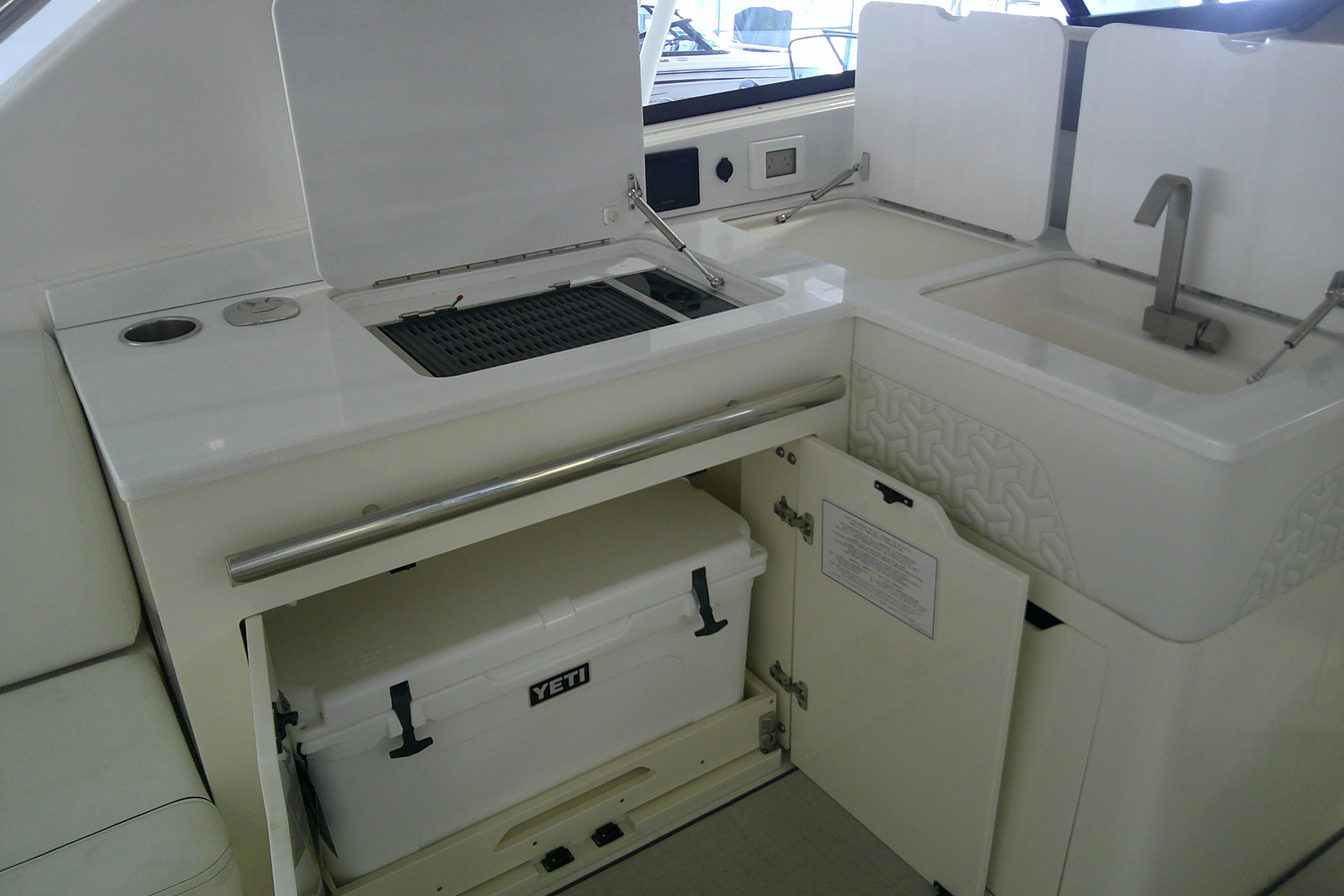 2023 Regal LX36 yacht kitchenette with sink, grill, and Yeti cooler storage.