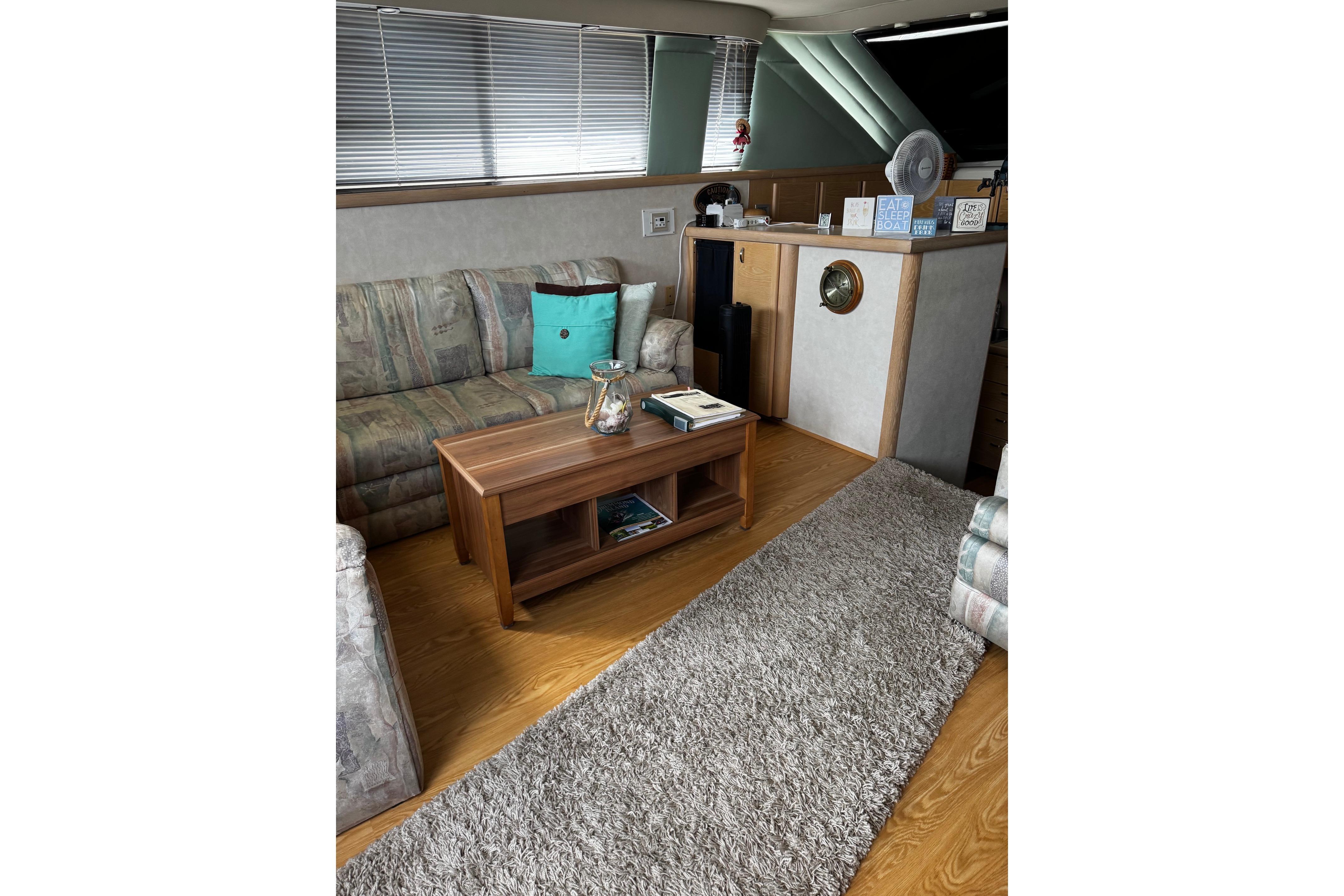 Interior of 1991 Silverton 46 Motor Yacht with cozy seating and wooden decor.