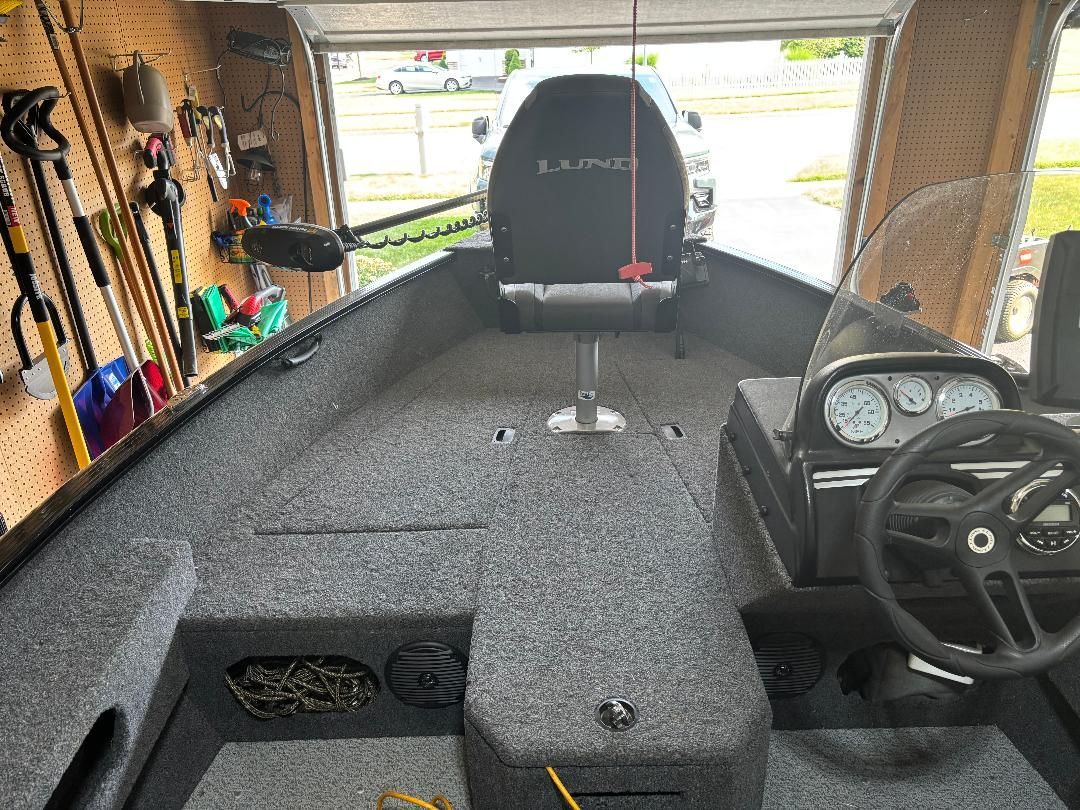 Interior view of a 2022 Lund Advent boat in a garage.