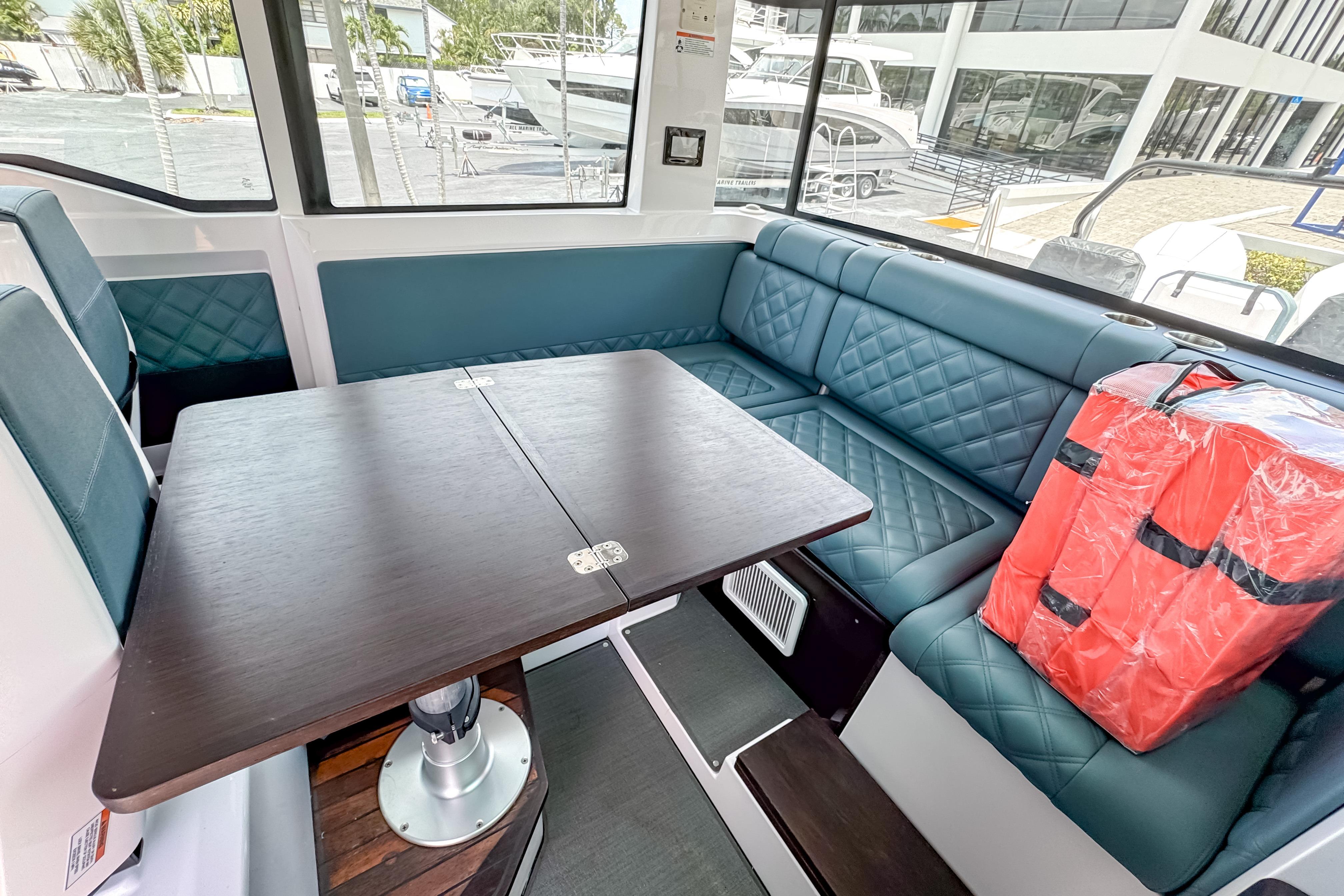 Interior of 2023 Axopar 37 XC Cross Cabin with seating and table.