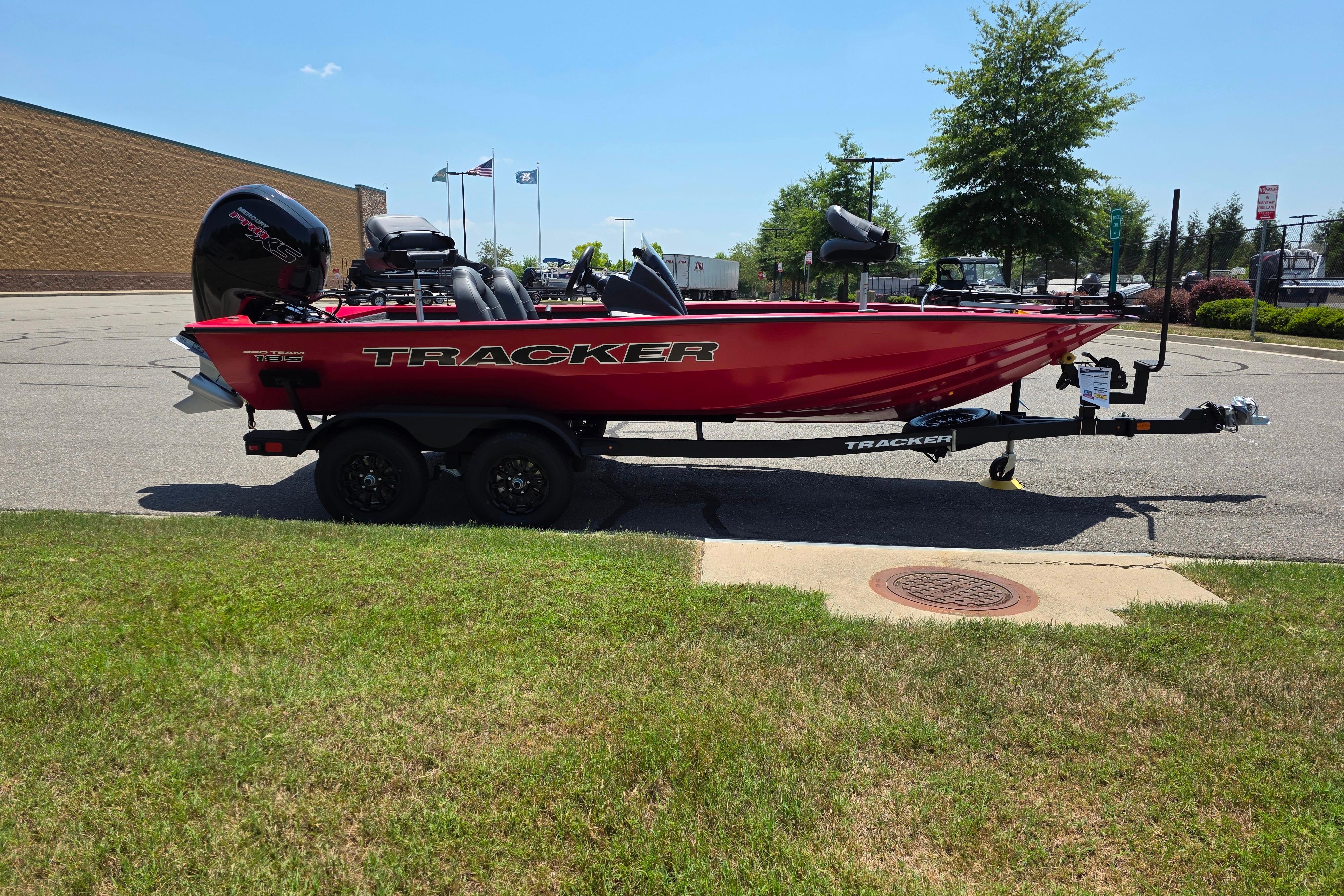 2026 Tracker Pro Team 195 boat on trailer, parked outdoors, side view.