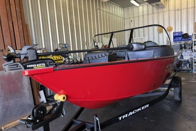 2026 Tracker Pro Guide V-16 WT boat in a garage, featuring Minn Kota trolling motor.