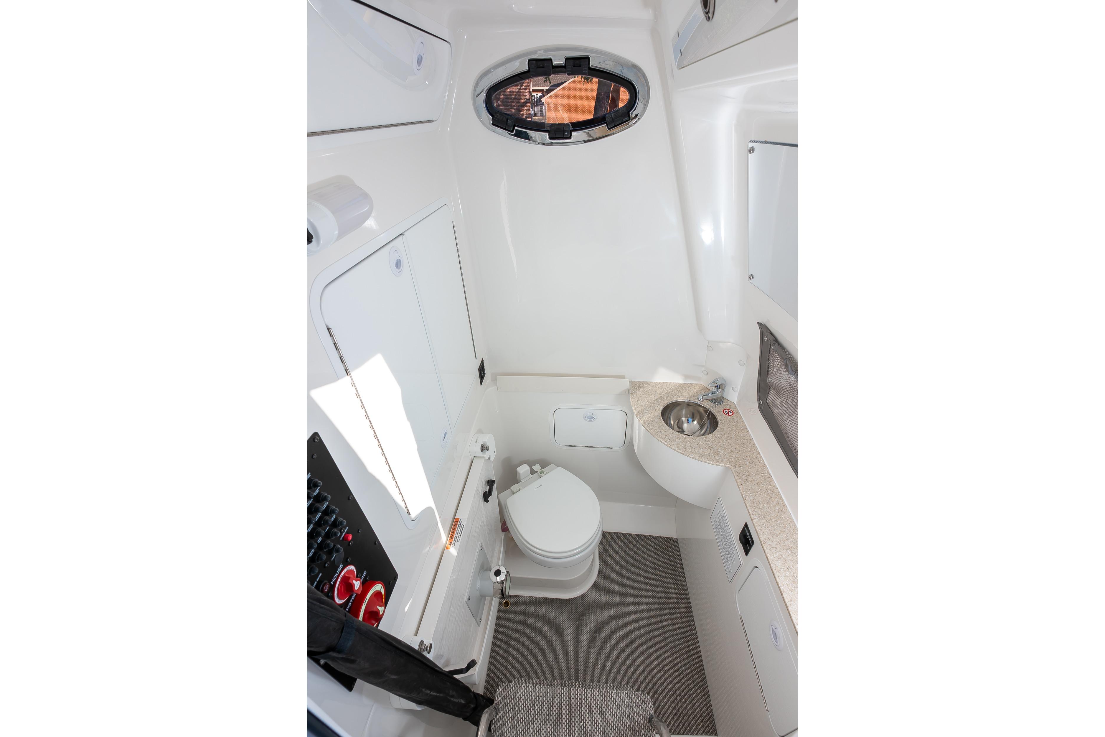 2026 Regulator 28 boat interior with compact bathroom and modern amenities.