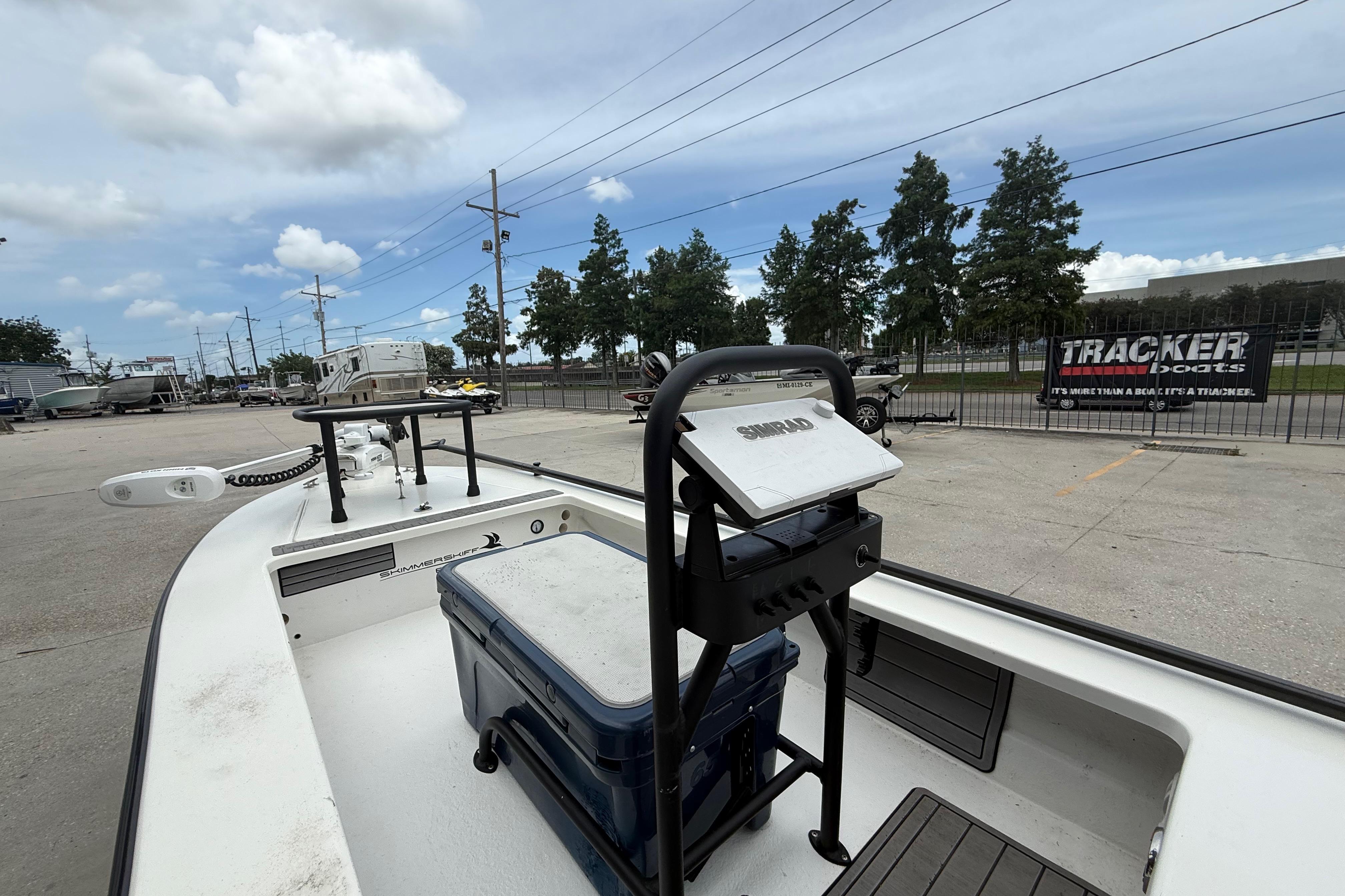2020 Skimmer Skiff 14 boat with equipment, parked outdoors under a cloudy sky.