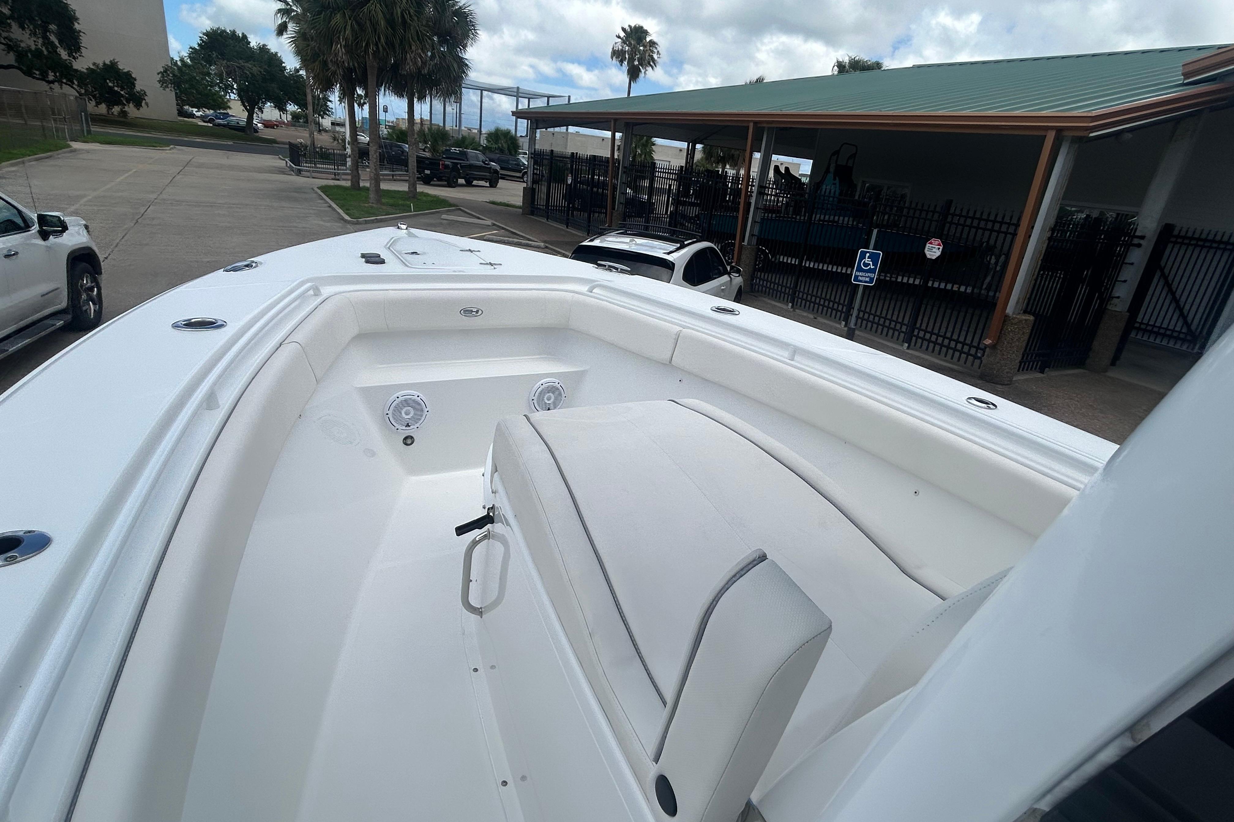 2023 Sea Hunt Gamefish 27 Coffin Box boat, spacious deck, white interior, parked outdoors.