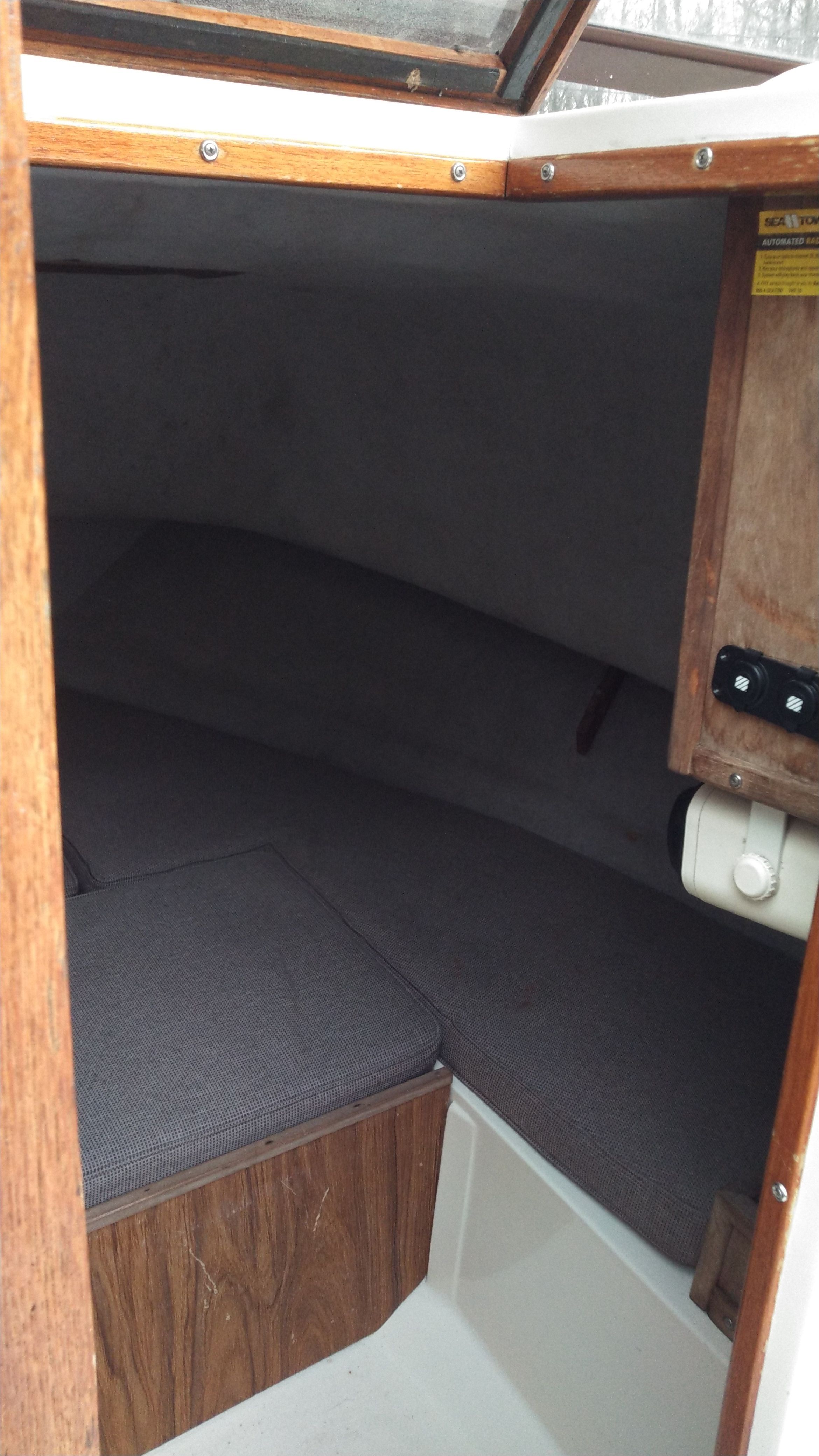 Interior of a 1989 Mako 240 Walk Around with cushioned seating.