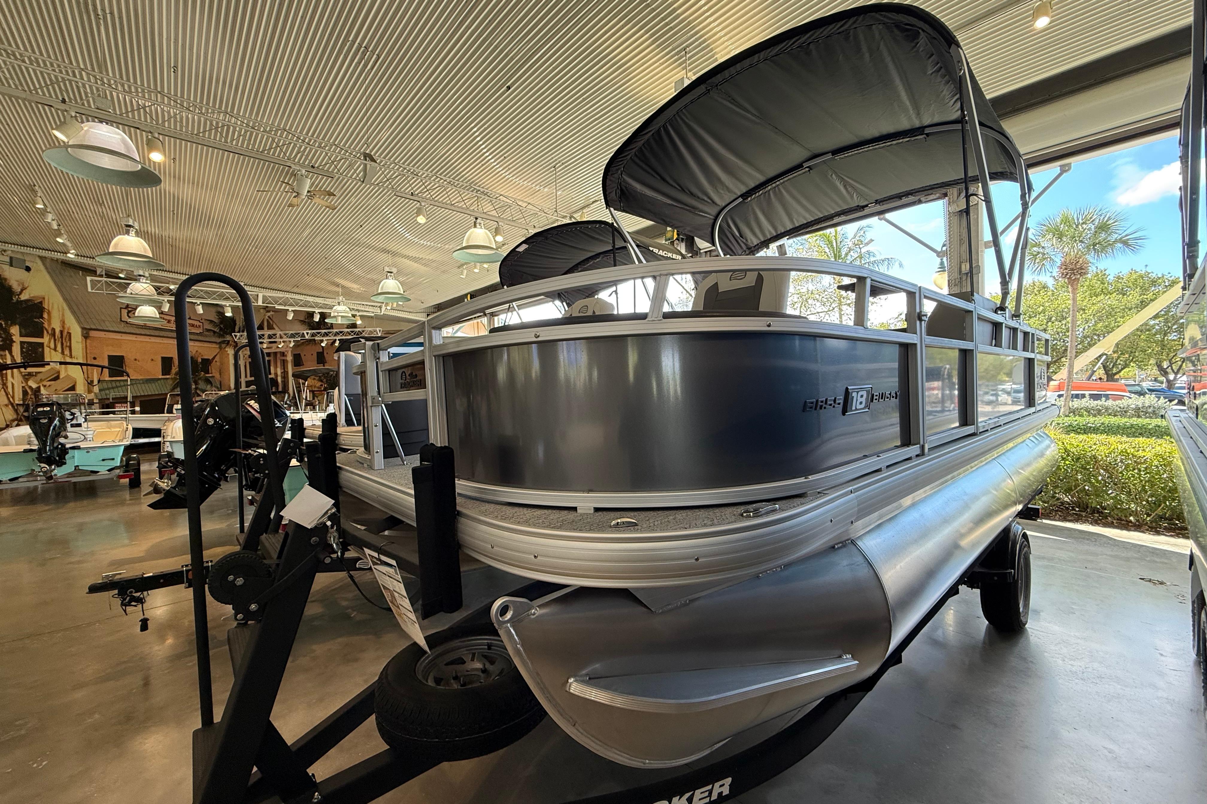 2026 Sun Tracker Bass Buggy 18 DLX pontoon boat displayed indoors.