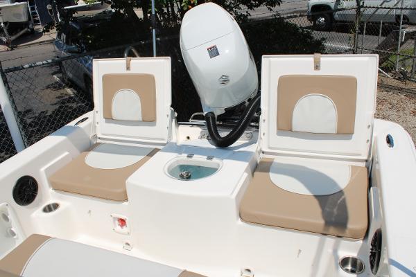 2023 Sundance DX20 boat interior with beige seating and motor.